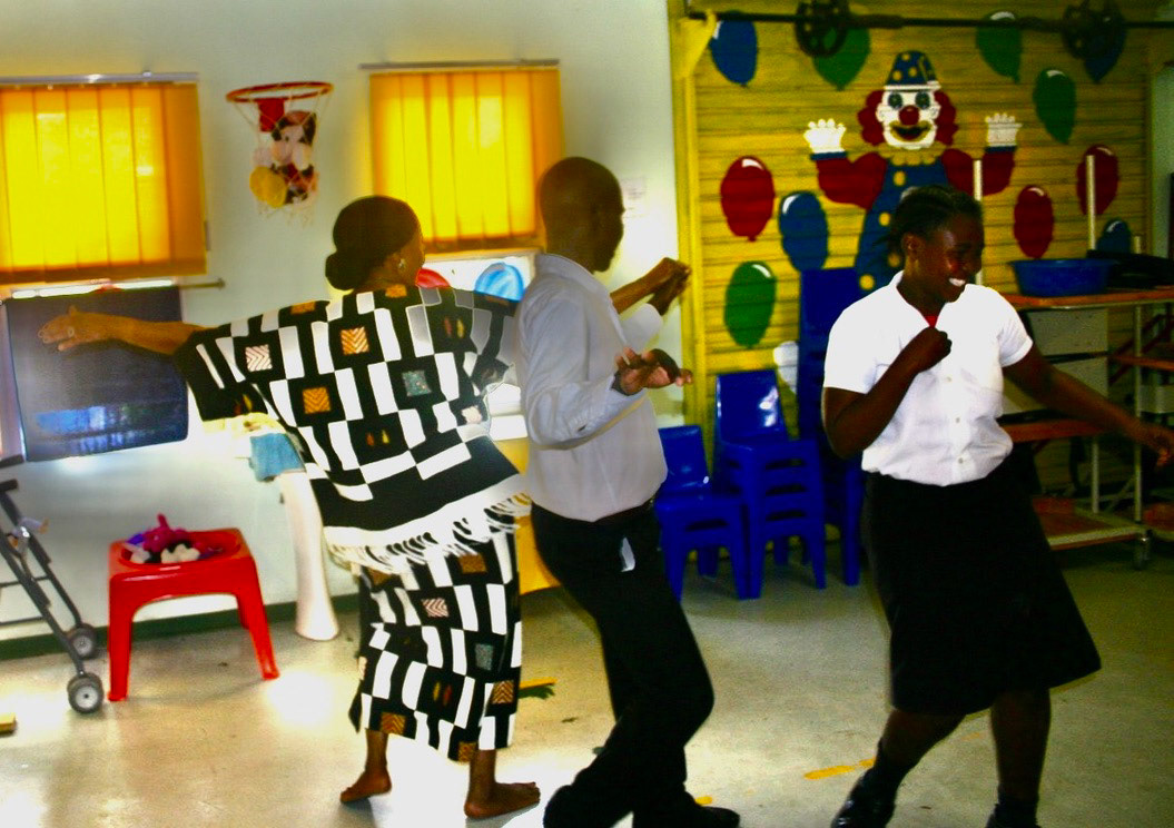 Maxine swinging with students in social dance class 