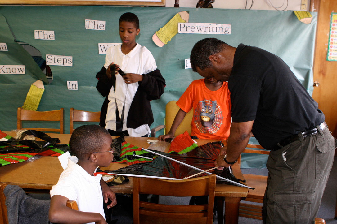 Robert Smith teaching kite making to Shabazz Academy male mentoring group