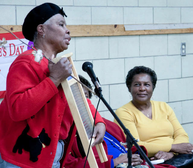 Grandmother  "G G" providing information to Shabazz staff & students about the function of a washboard