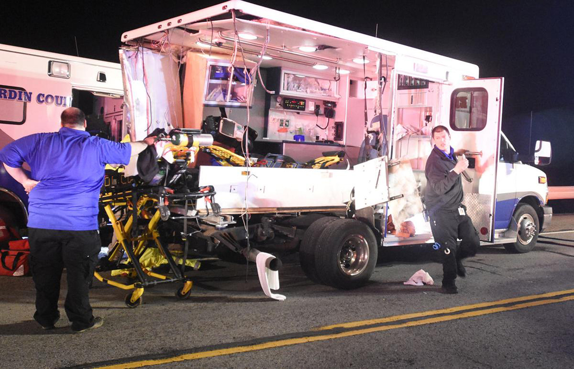 A first responder steps down from inside a wrecked ambulance after drawing up a medication while working at the scene of the wreck between two ambulances Friday, Feb. 23, 2018, on Joe Prather Highway in the Radcliff, Kentucky, area.  (Jill Pickett/The News-Enterprise)