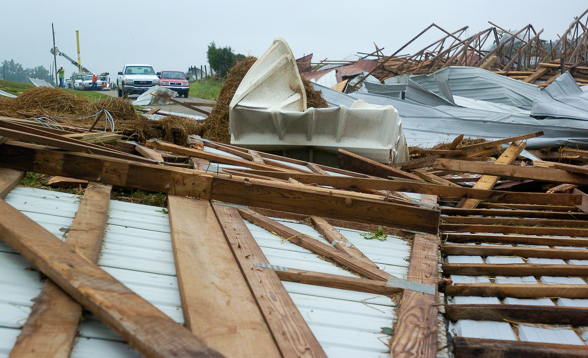 Debris from a barn destroyed in overnight storms at Rock Brothers Dairy in LaRue County, Kentucky, blocks Slack Road on Thursday, June 27, 2013. (Jill Pickett/The News-Enterprise)