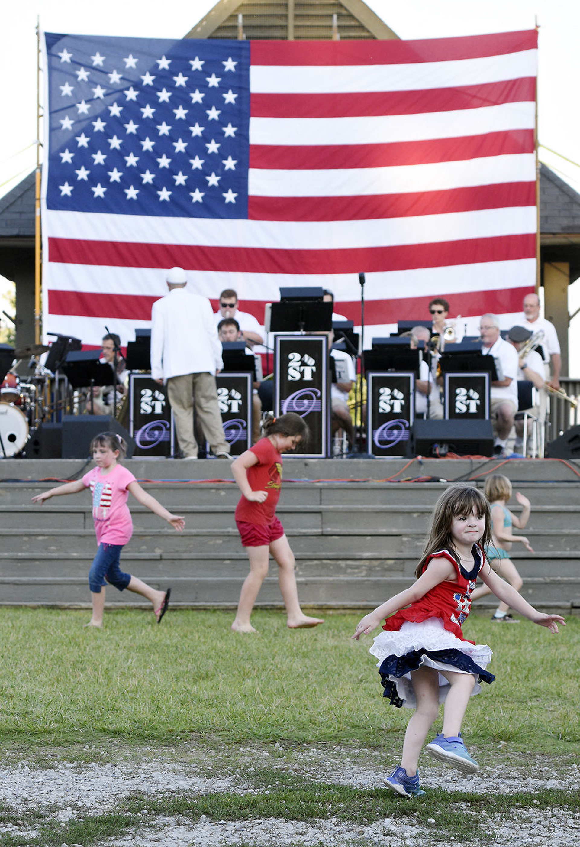 Children dance Wednesday, July 4, 2018, as the Owensboro Symphony Orchestra 2nd St. Big Band performs during the Founders' Day celebration at Freeman Lake Park in Elizabethtown, Kentucky. (Jill Pickett/The News-Enterprise)