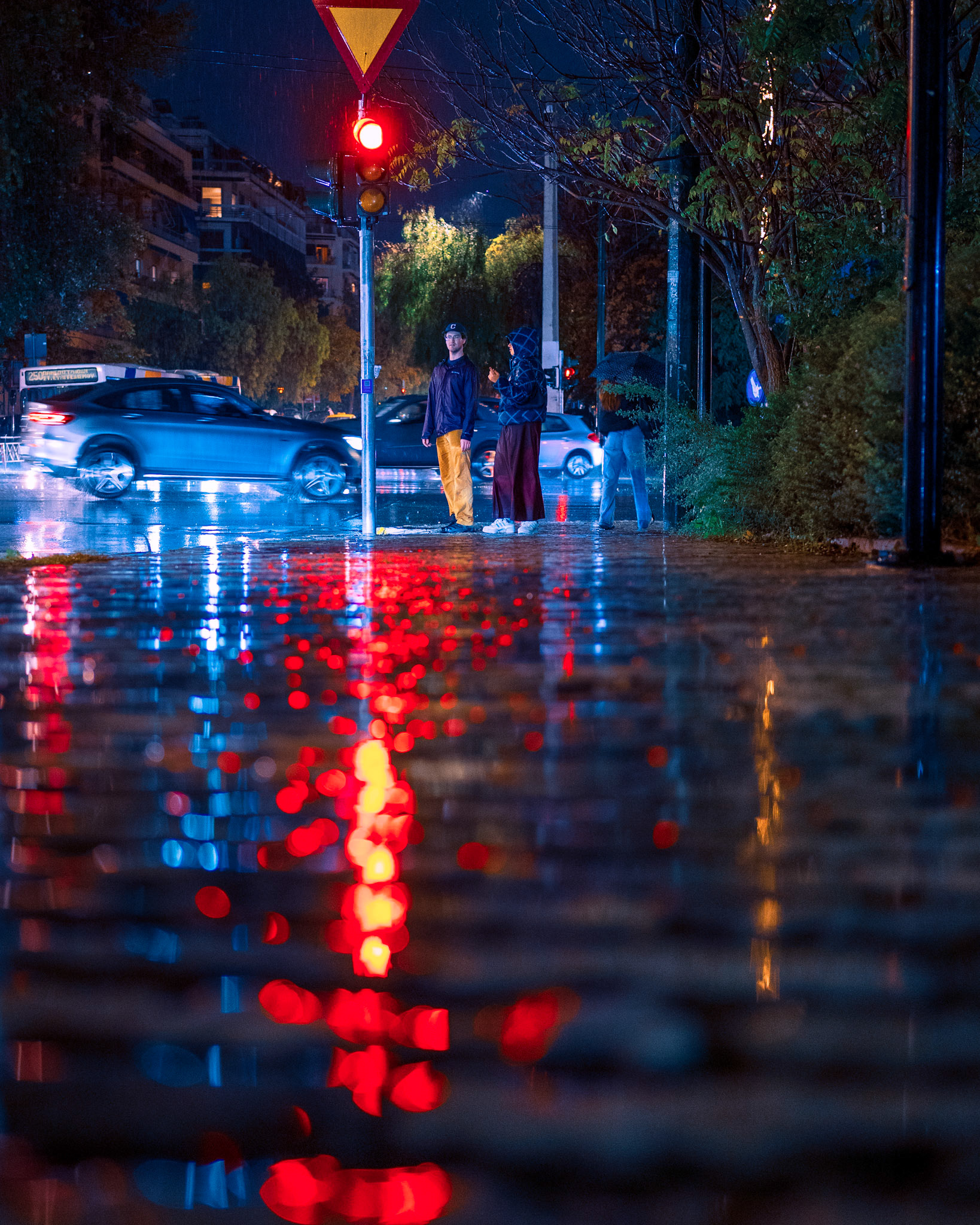 There is a unique beauty in the moments where we are forced to stand still. Tonight, the rain turned the #pavement into a mirror, stretching the red #trafficlight🚦 into a long, liquid warning.While the cars rushed by, these two stood frozen in the red glow, in a brief moment of stillness in a restless city. I shot this from a low angle to make the #reflection the main character. It shows that even a grey, #rainynight in Athens is full of vibrant colors, if you look closer. When it rains, do you rush to get home, or do you linger to watch the reflections?