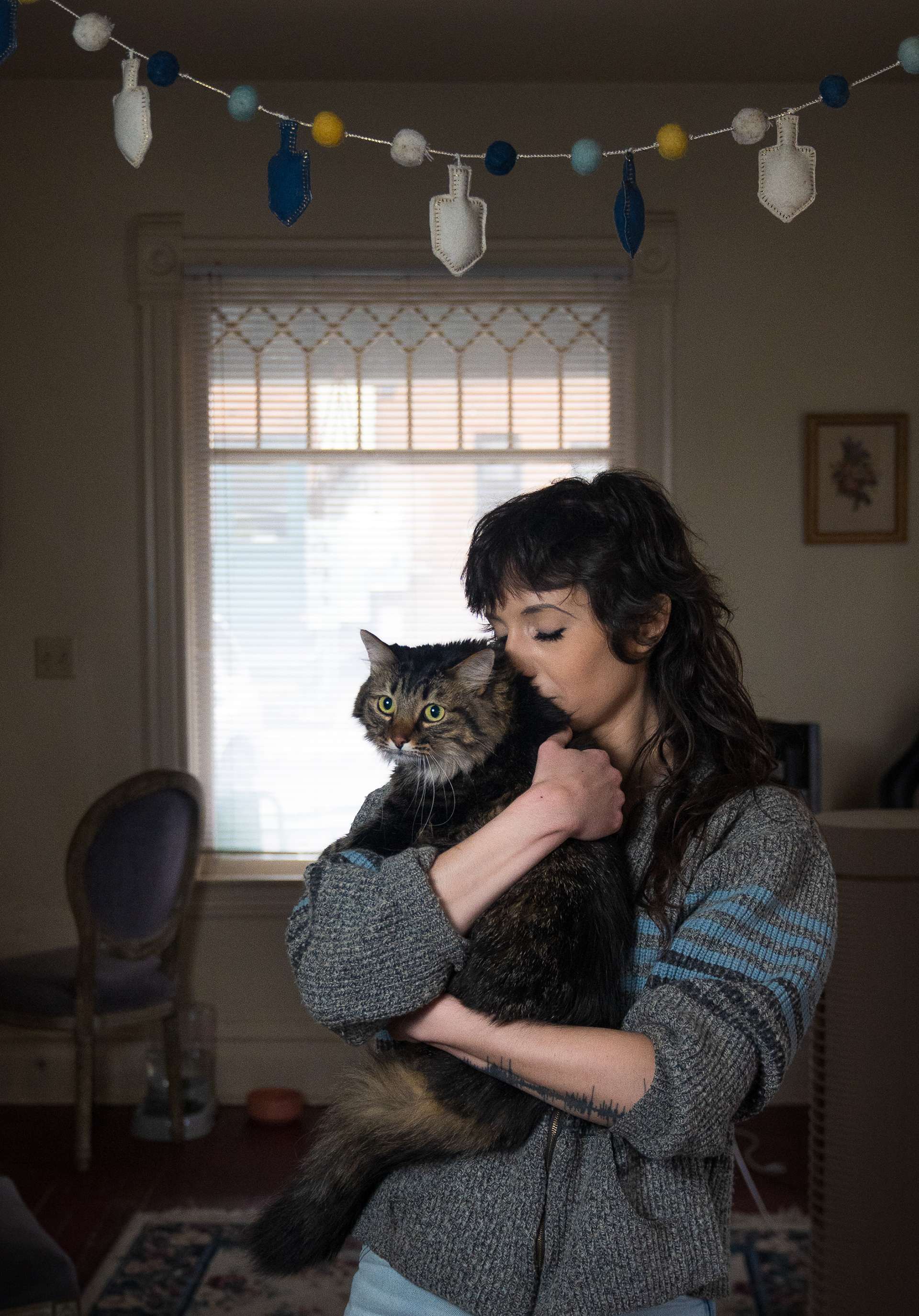 Jay Schutze embraces her 9-year-old rescue tabby cat, Calypso, in their apartment on Feb. 9. Schutze adopted Calypso when she lived in Colorado, where she worked in animal rehabilitation, before moving to the University to study wildlife biology.