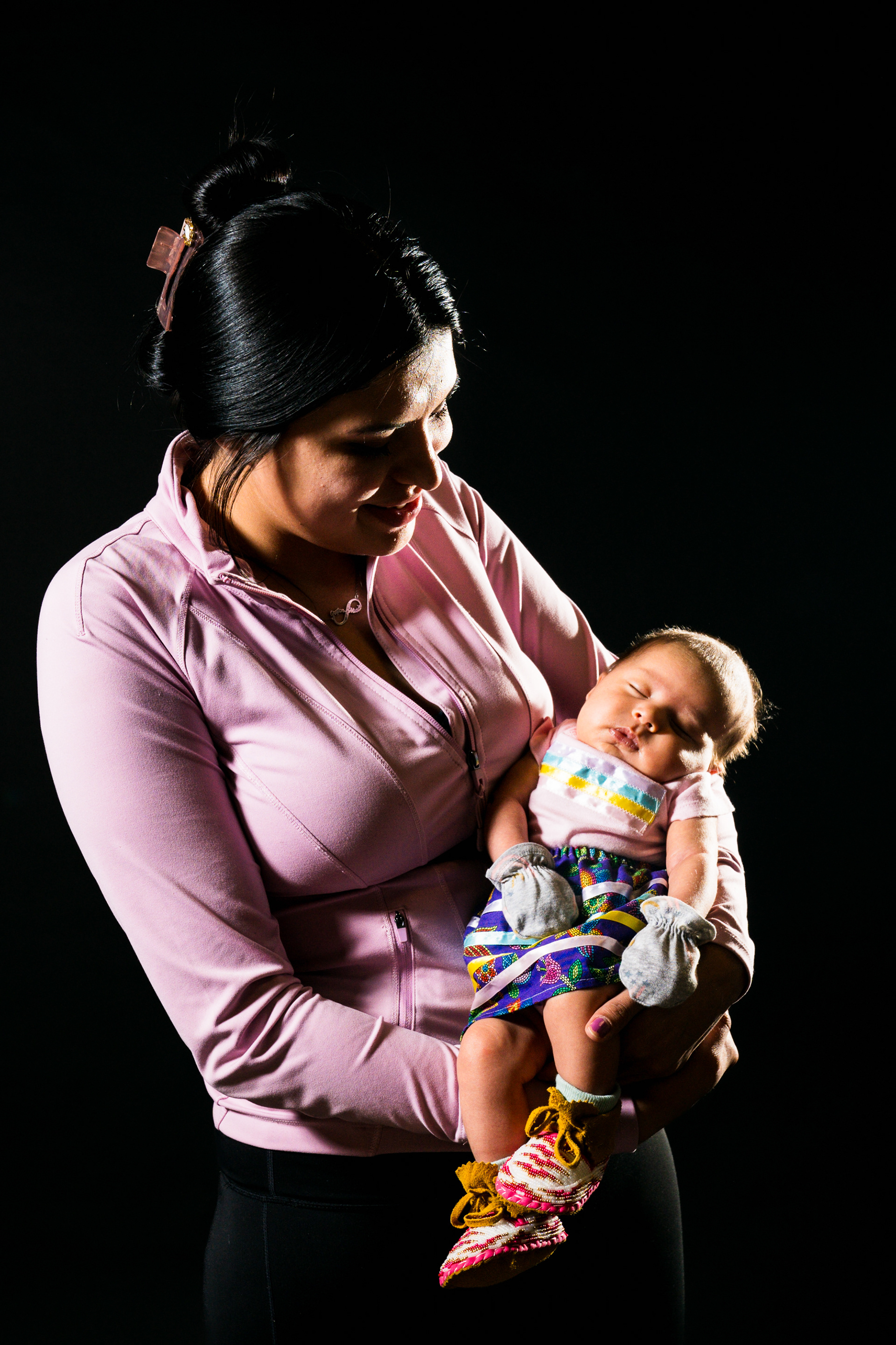 Michiah Kicking Woman of the Blackfeet tribe from Browning Montana with her one-month-old baby Hazel at first Kiyiyo Pow Wow together.
