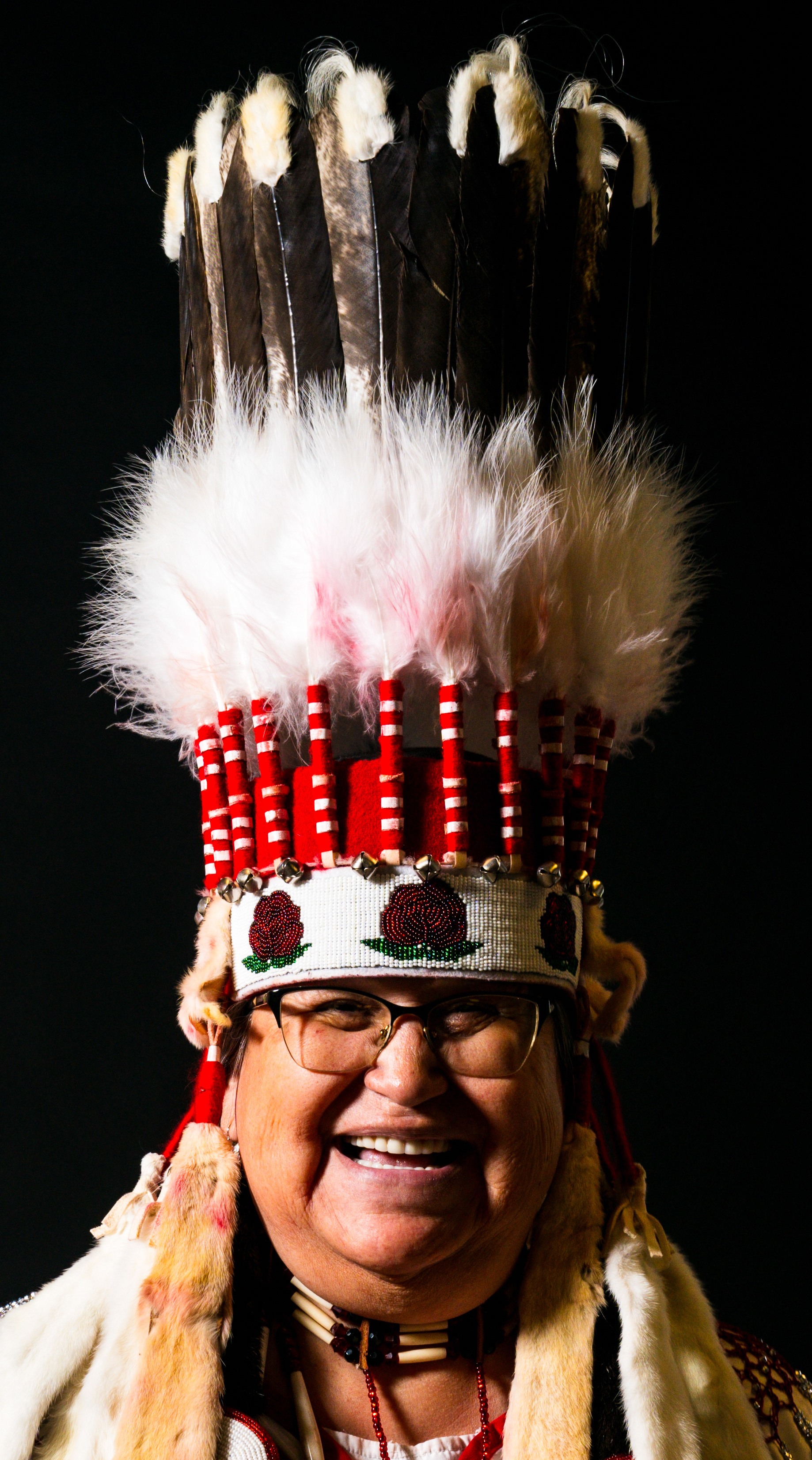 Charlene Plume is from Stand Off, Alberta, Canada, is an enrolled member of Blood Tribe, and makes stand-up headdresses like the one she is wearing. She said it was how the Blackfeet were recognized by other nations. Recently, Plume made a stand-up headdress for Academy Award winning actress Lily Gladstone.