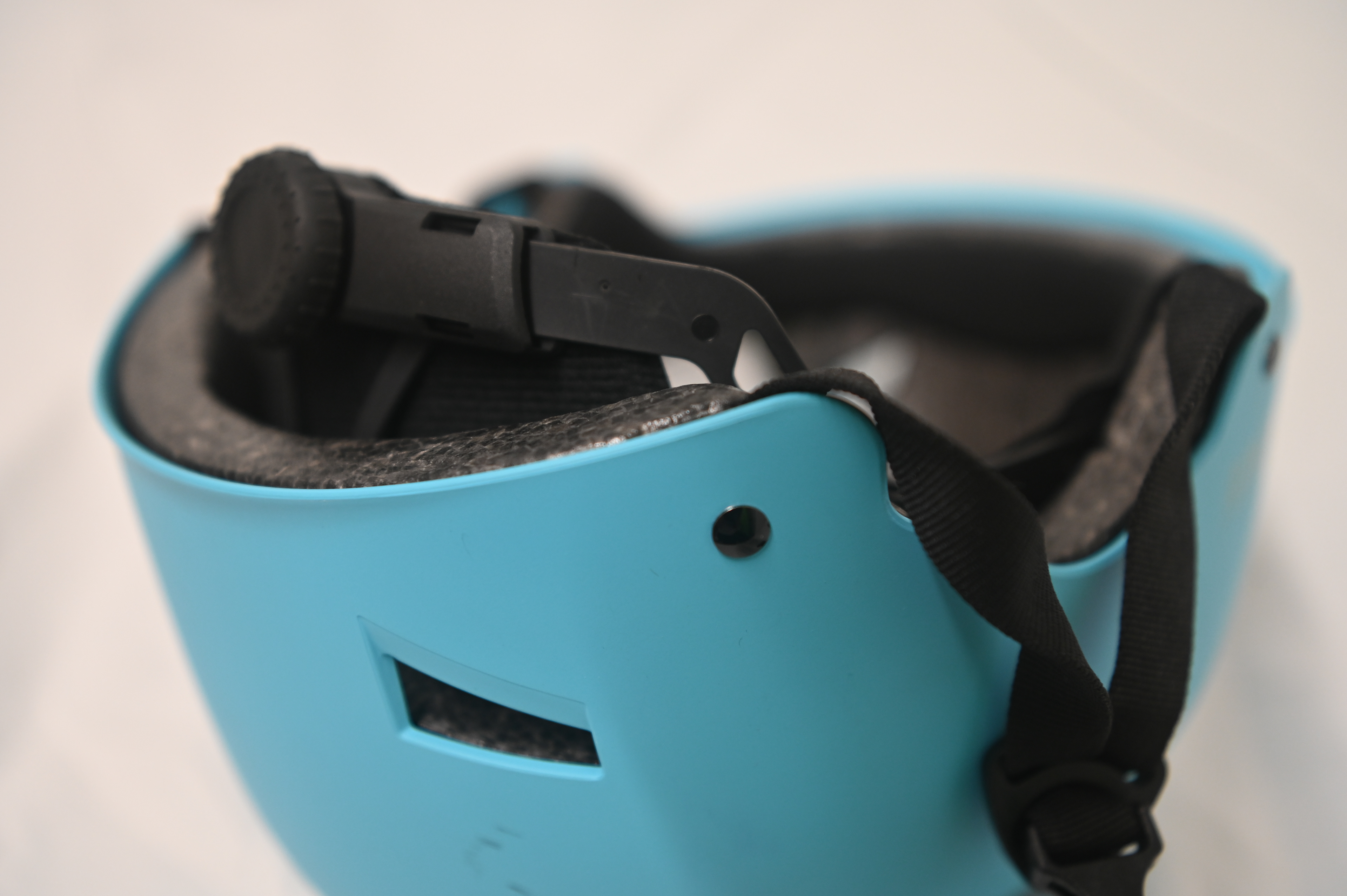 Occipital stabilizer held in place with overmoulding and a rivet. 