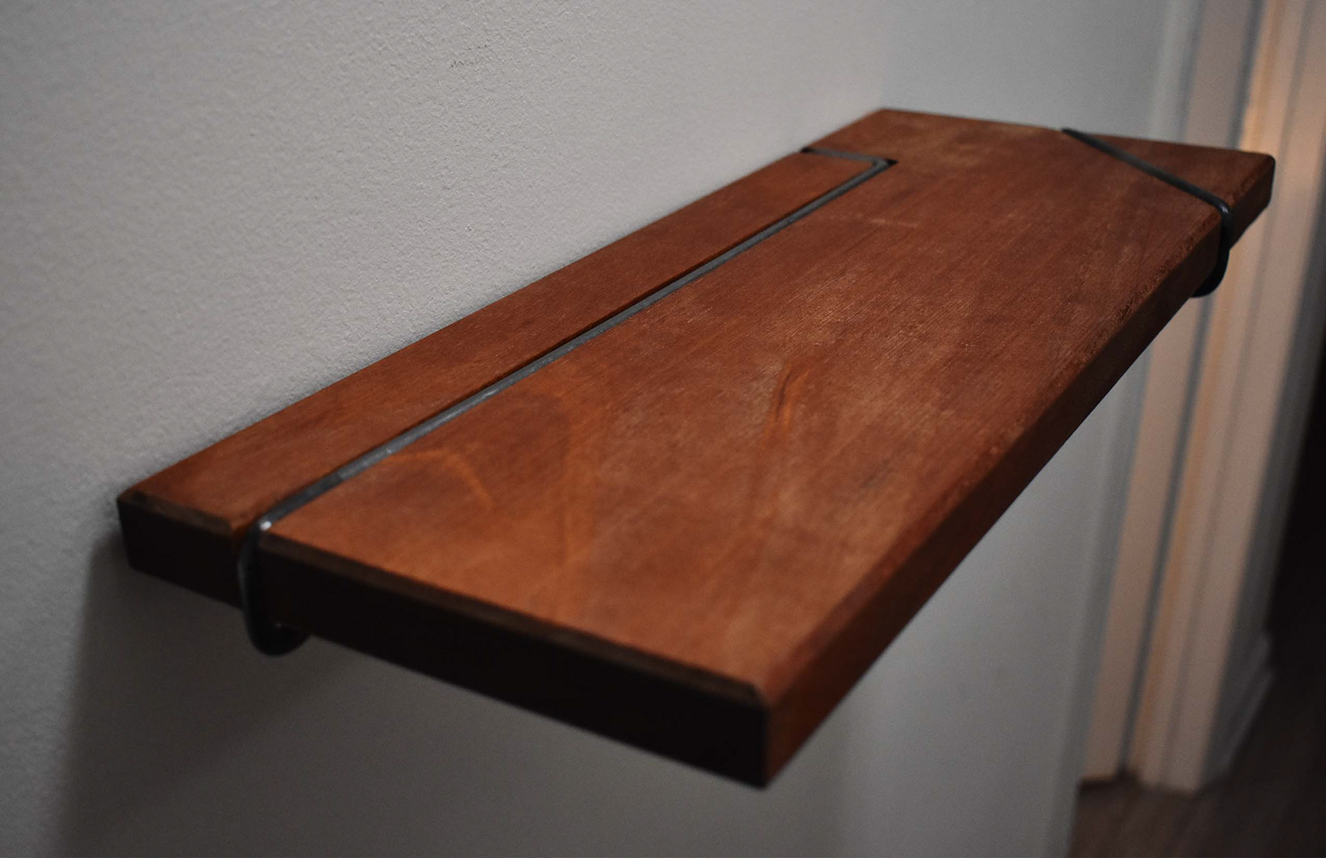 Steel is Pressed into Mahogany Creating a Beautiful Small Shelf