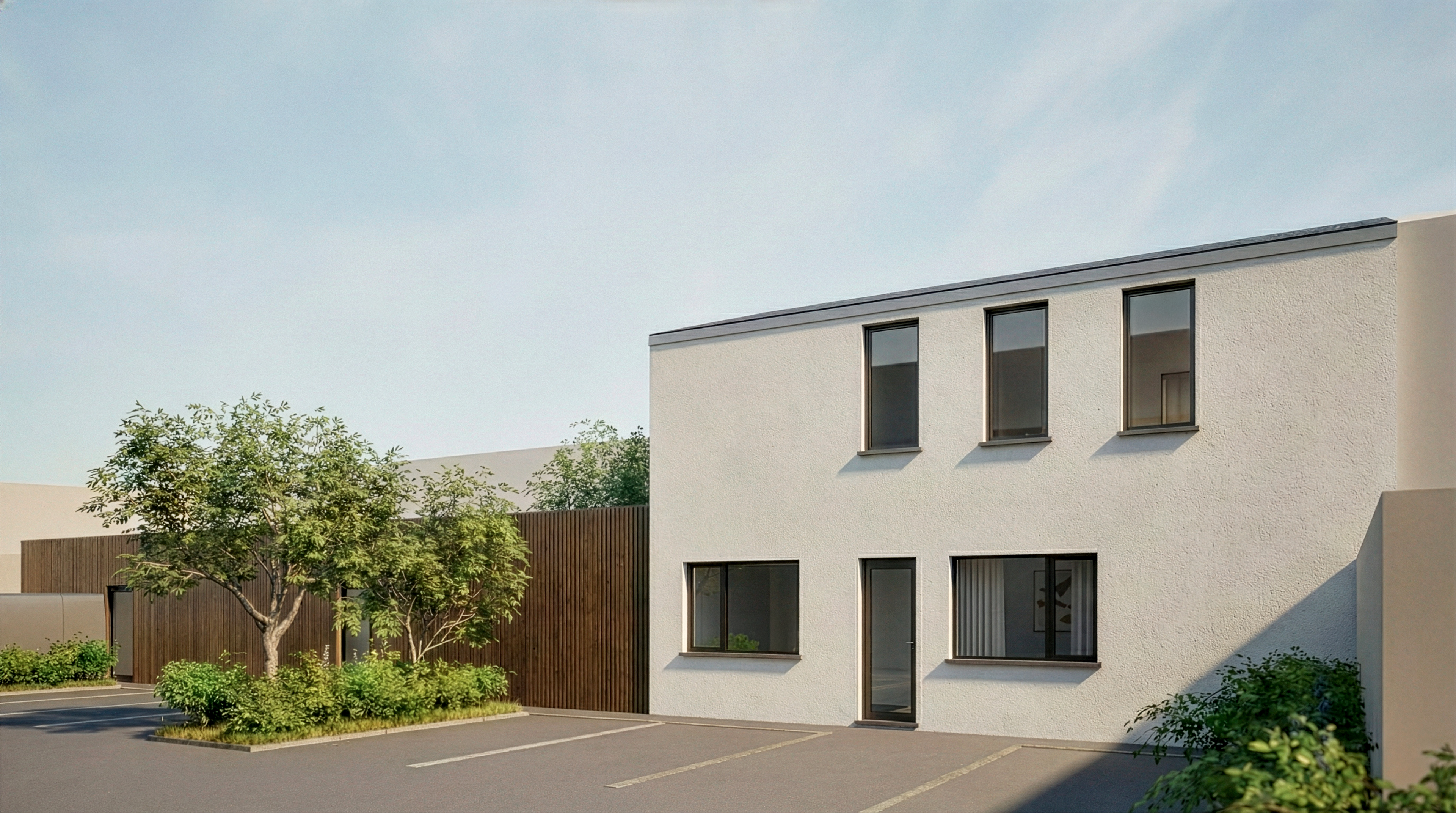 Façade arrière du logement rénové avec stationnements et aménagements paysagers