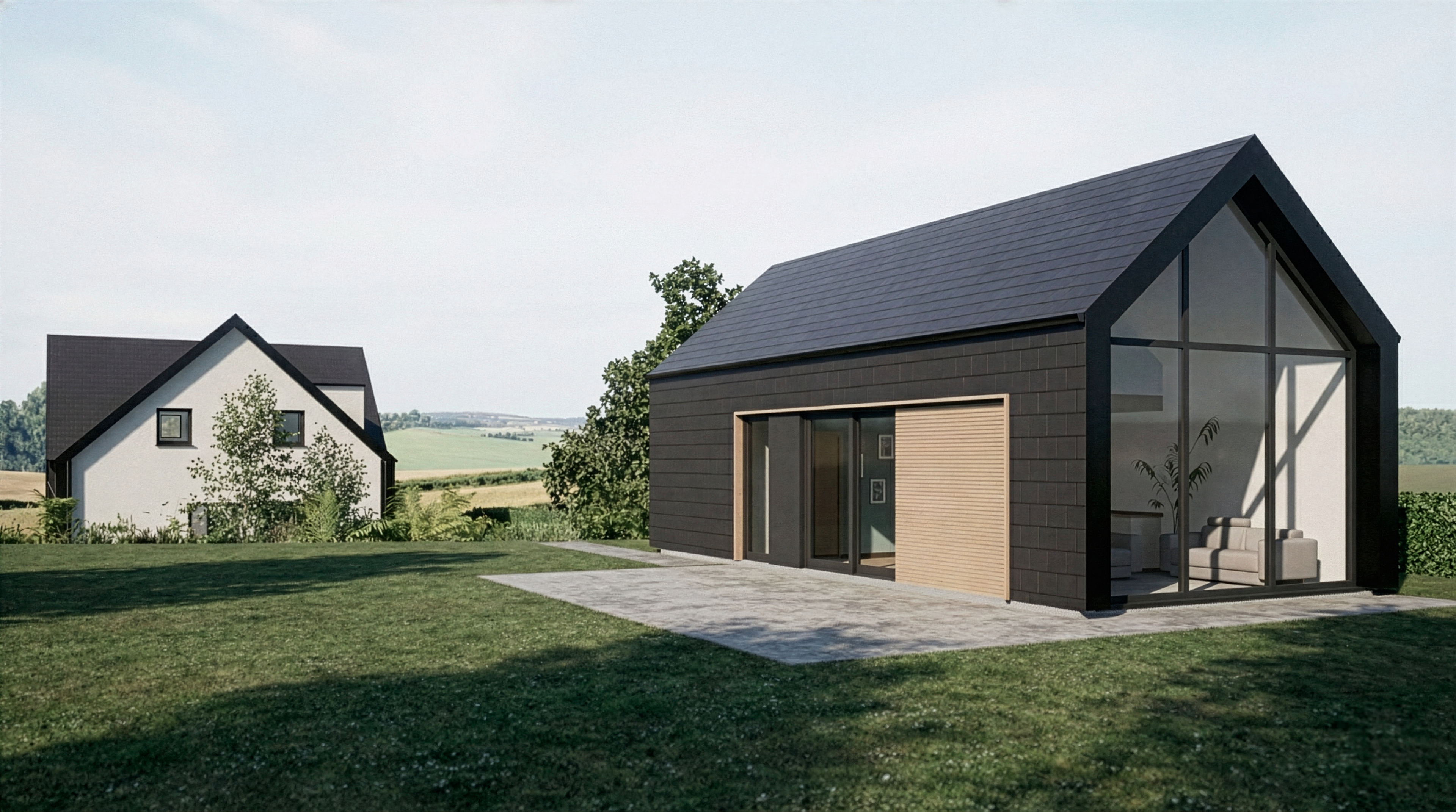 Annexe indépendante en fond de parcelle avec façades et toiture en tuiles anthracite et pignon arrière entièrement vitré.