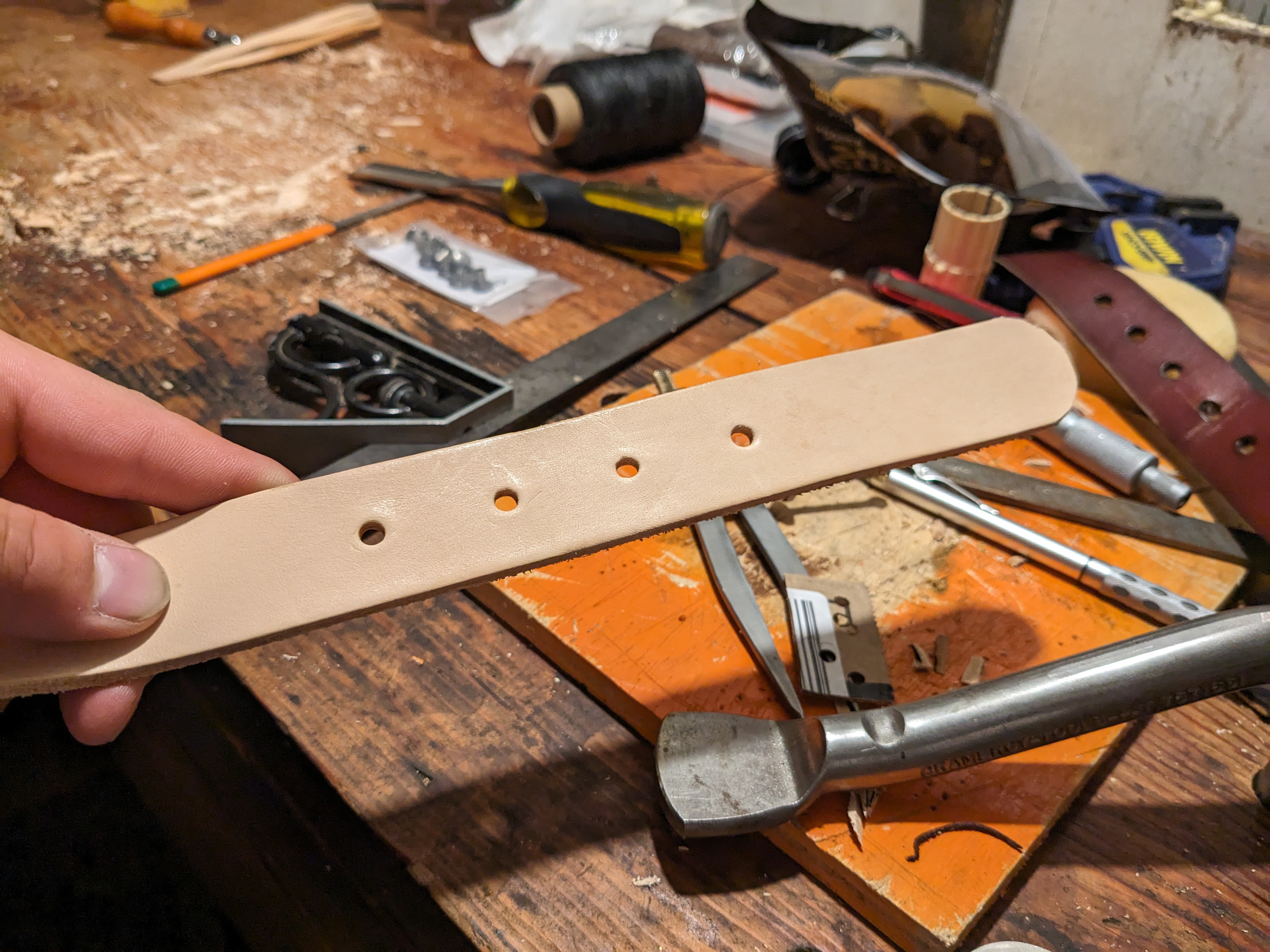 Punching holes for the buckle.