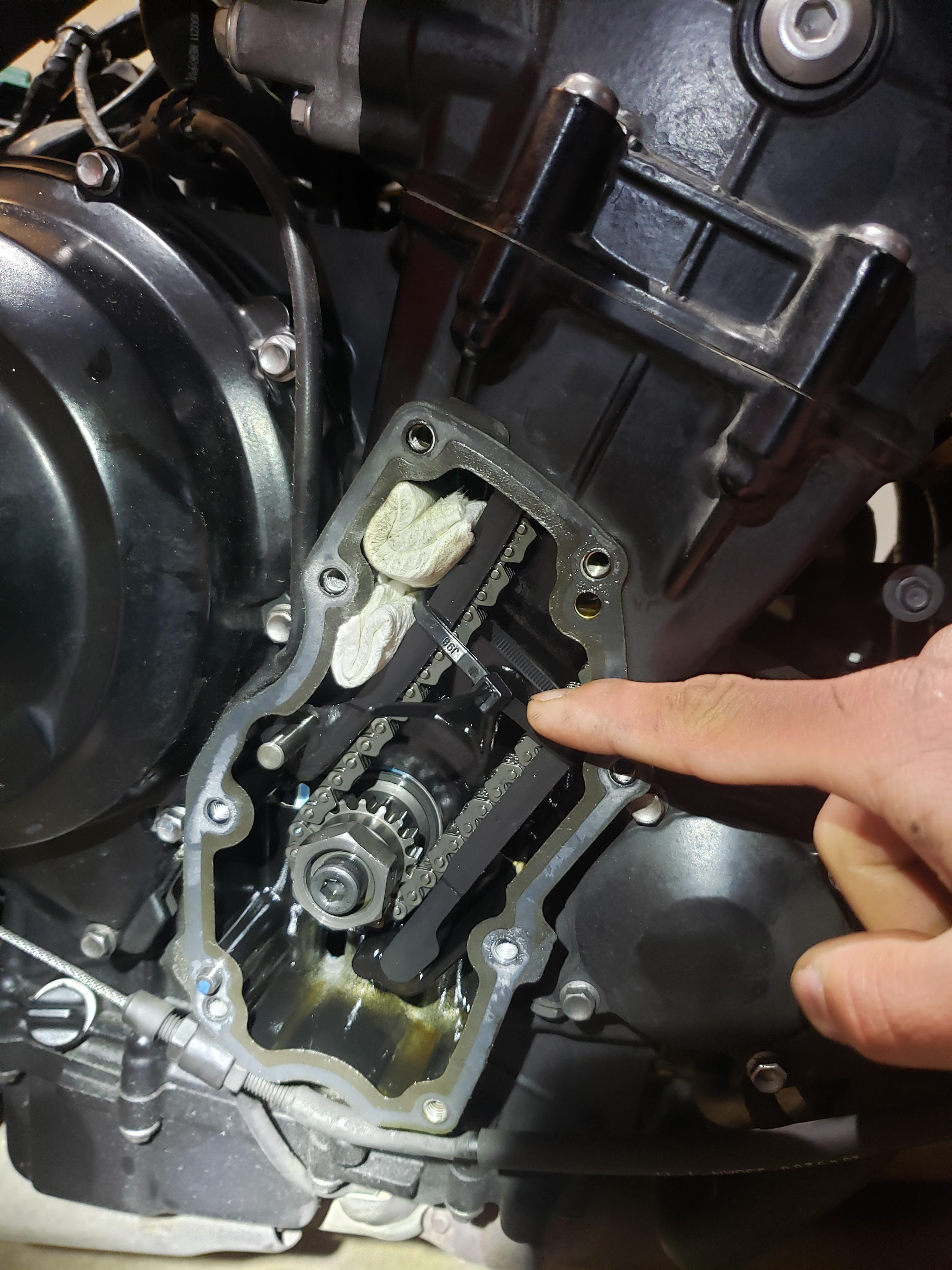 Make sure to jam the timing chain guide so the chain doesn't skip teeth when you remove the tensioner.