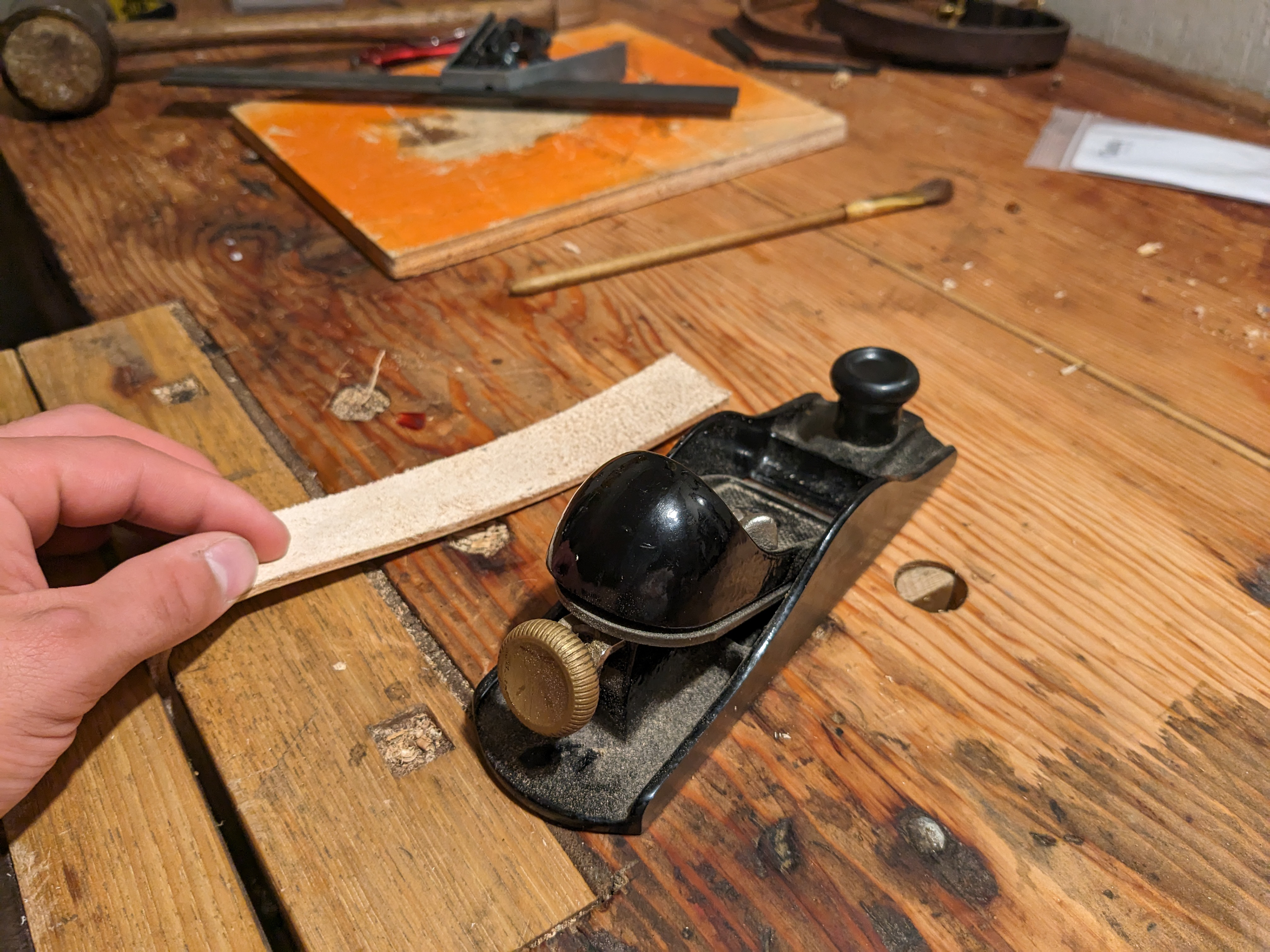 The area where the belt folds over itself needs to be thinned. A wood plane works alright!