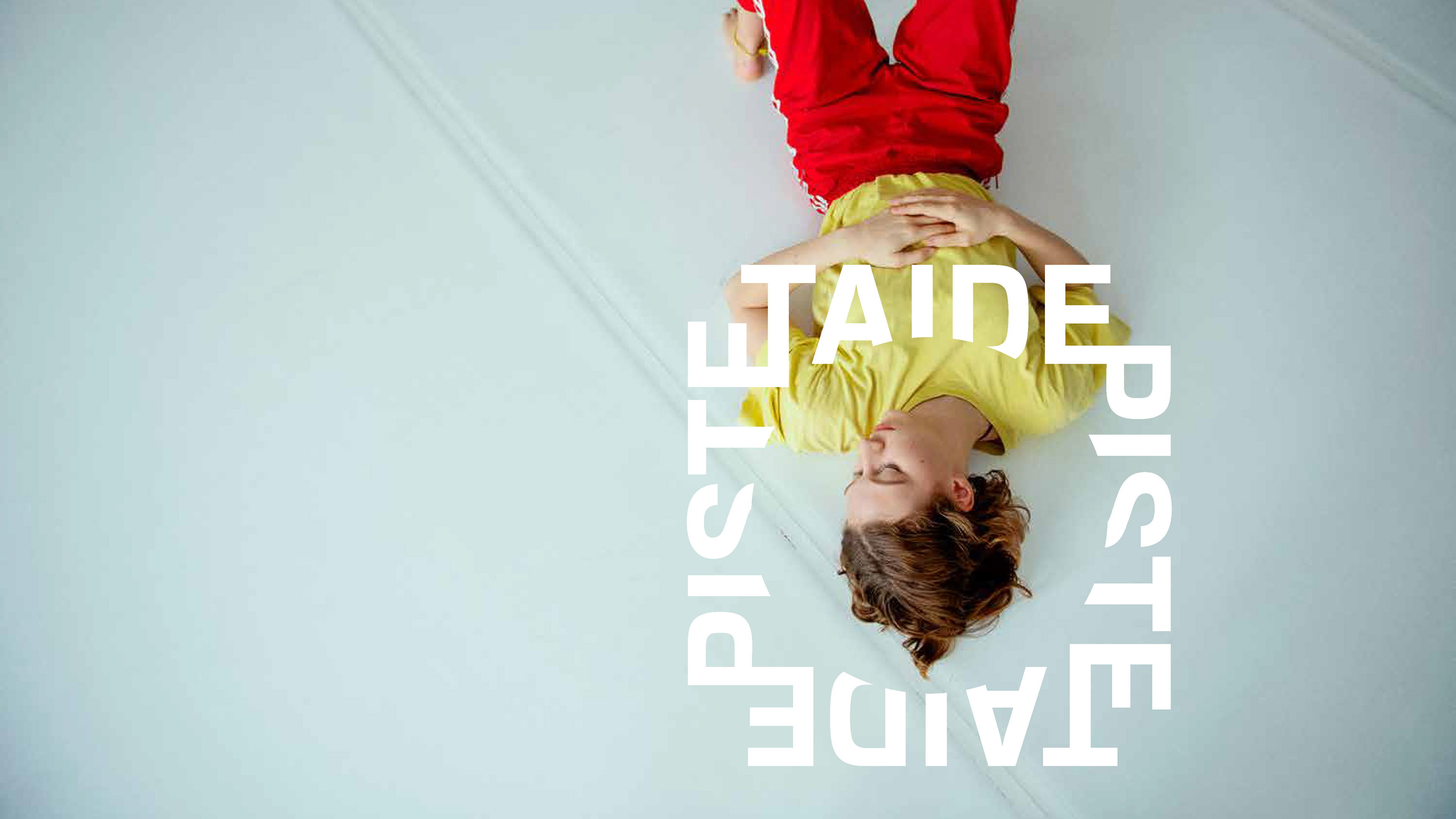 Person laying on floor with eyes closed. Logo graphic is centered around persons head.