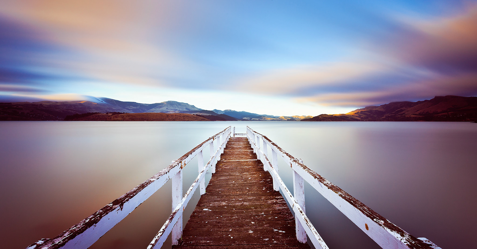 Colourful sunrise at a jetty in Lyttelton Harbour.