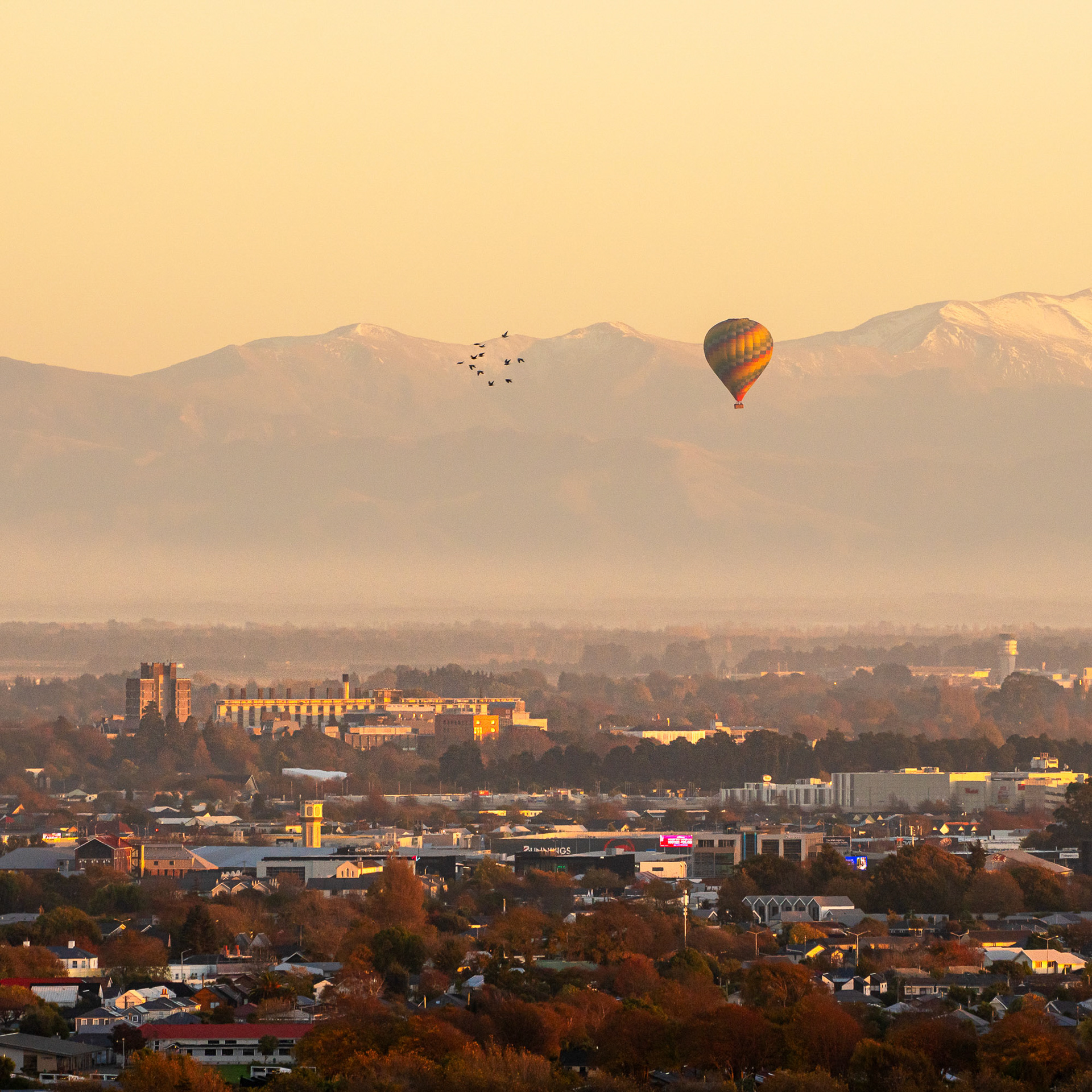 Early morning hot air balloon flight over the Canterbury Plains, viewed from Port Hills, Christchurch. 