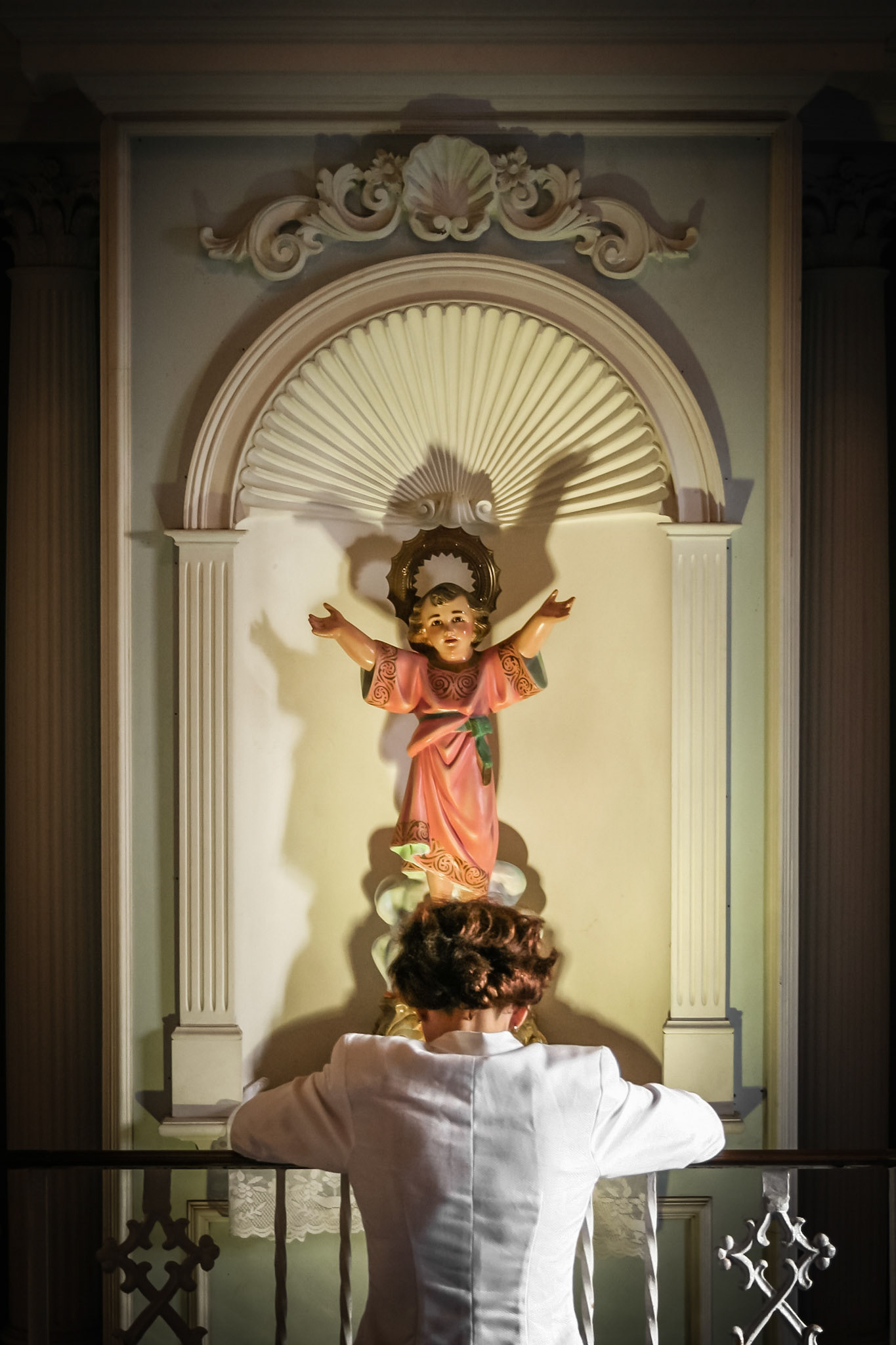 Mujer rezando en la Catedral Basilica Menor de San Juan Bautista.