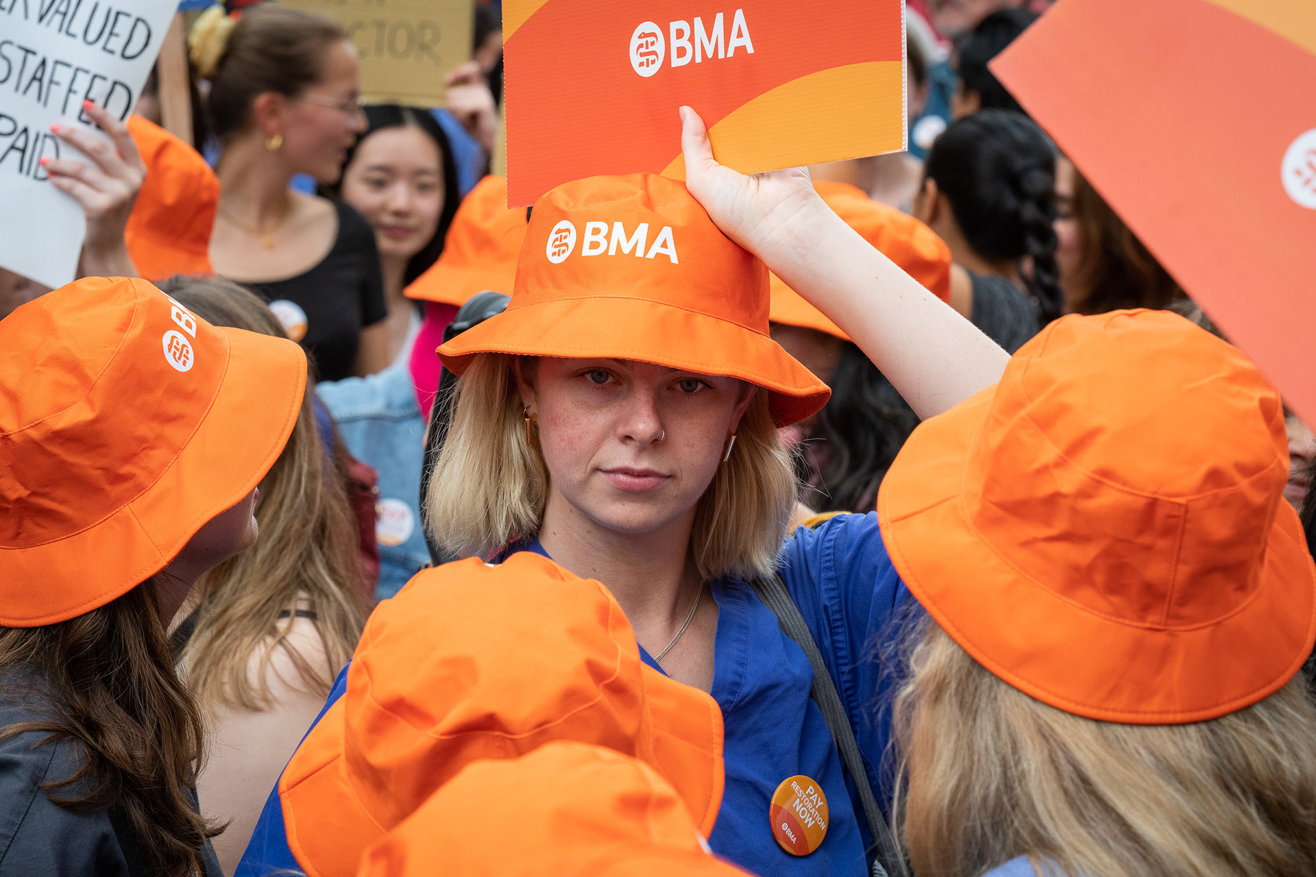 Junior doctors striking for a decent pay rise wear orange British Medical Association (BMA) hats. © Ron Fassbender