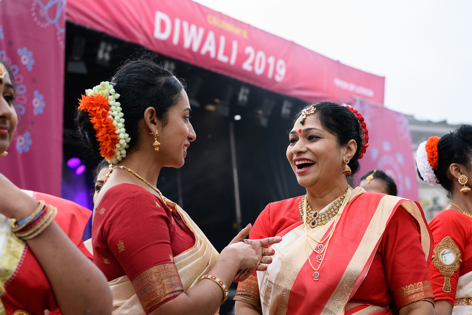 Two women dancers prepare to perform at the Diwali celebration in Trafalgar Square, London. © Ron Fassbender