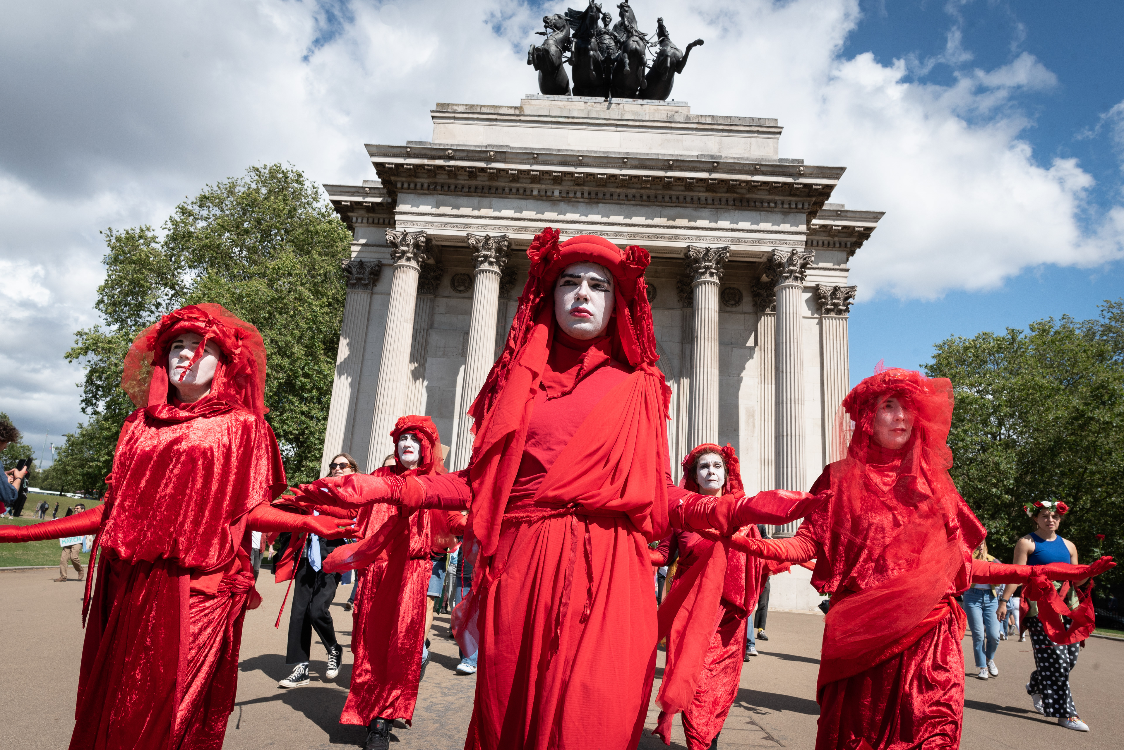 Red Rebel Brigade pass Wellington Arch during an action against proposed development of Rosebank oil field off the Scottish coast. © Ron Fassbender