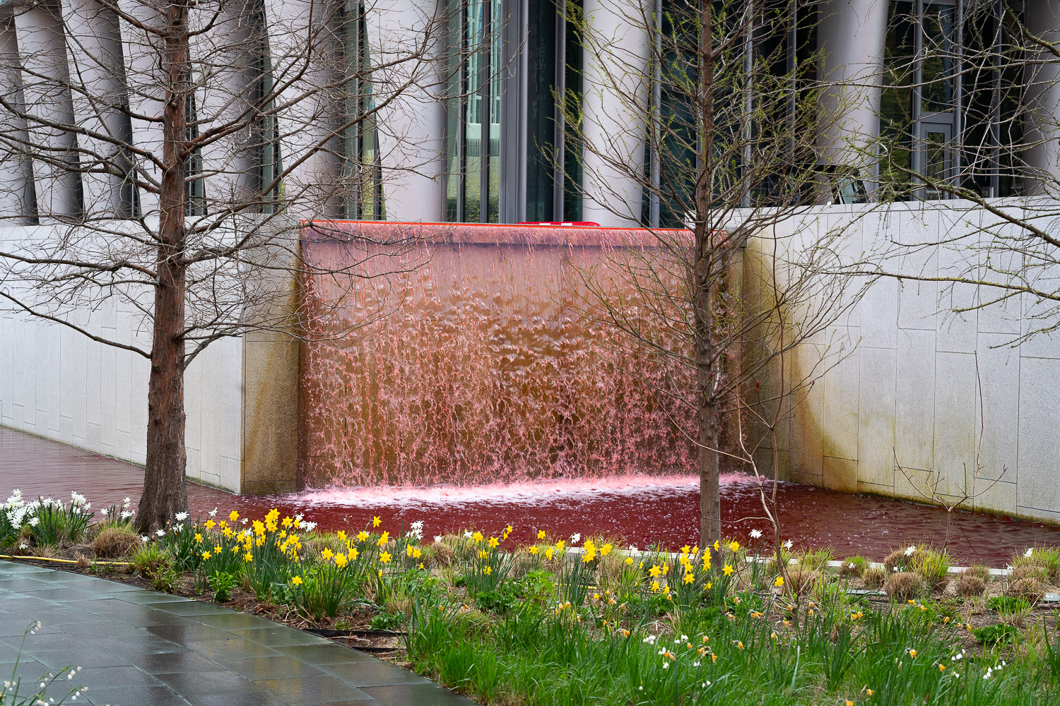 The US Embassy pond and waterfall filled with red dye in protest at arms sales to Israel. © Ron Fassbender
