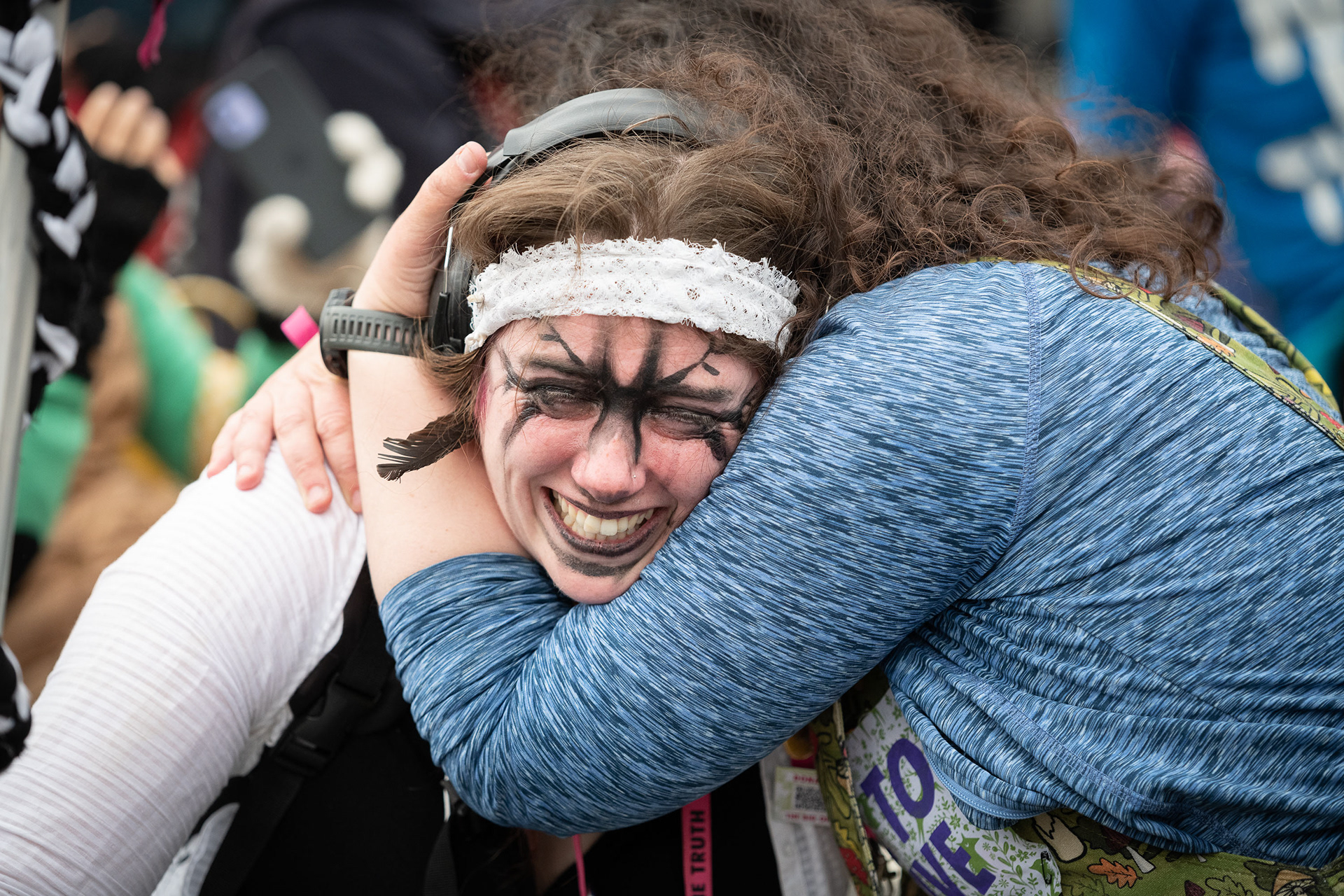An upset protester is comforted © Ron Fassbender