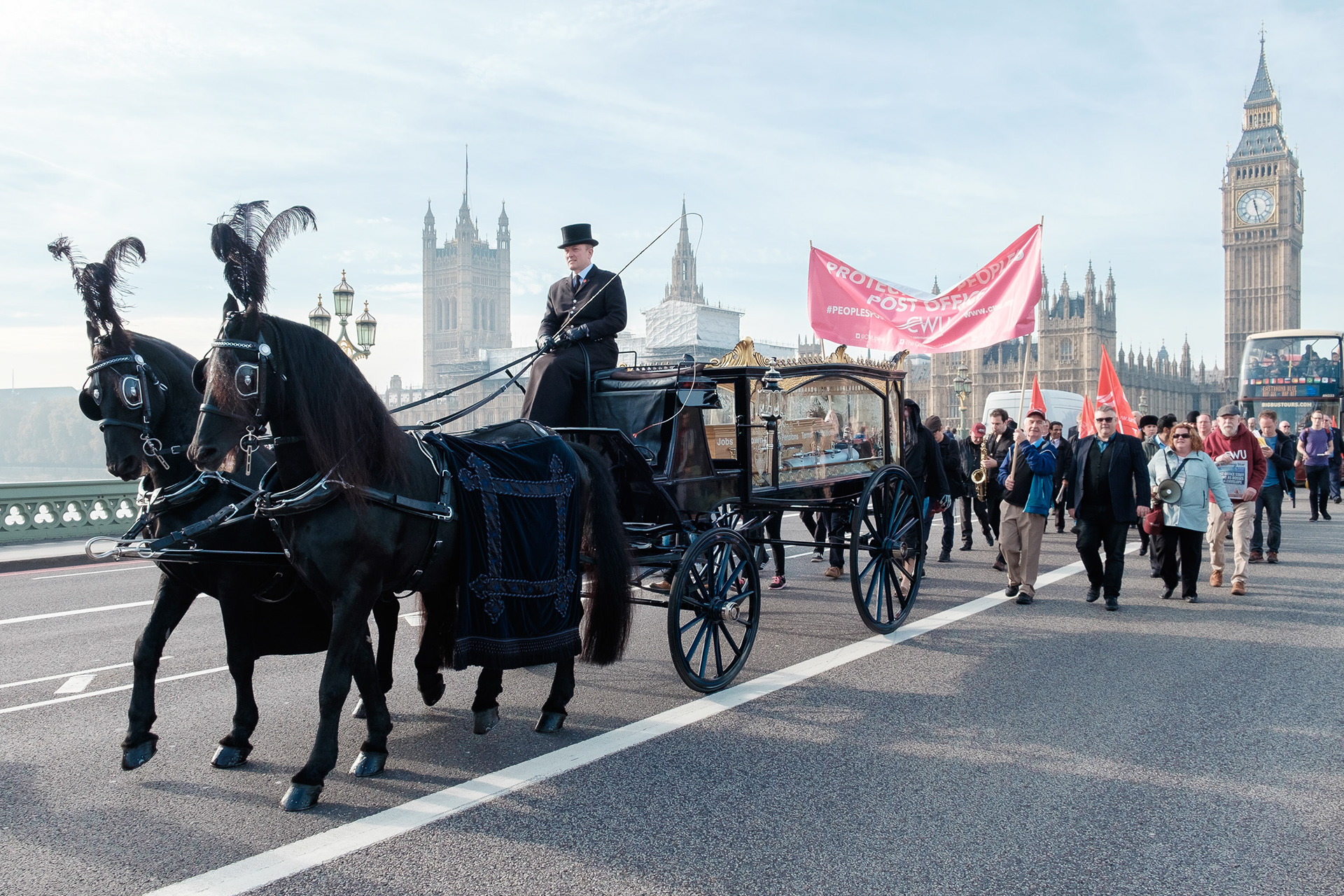 Funeral procession over Westminster Bridge staged by striking post workers. © Ron Fassbender