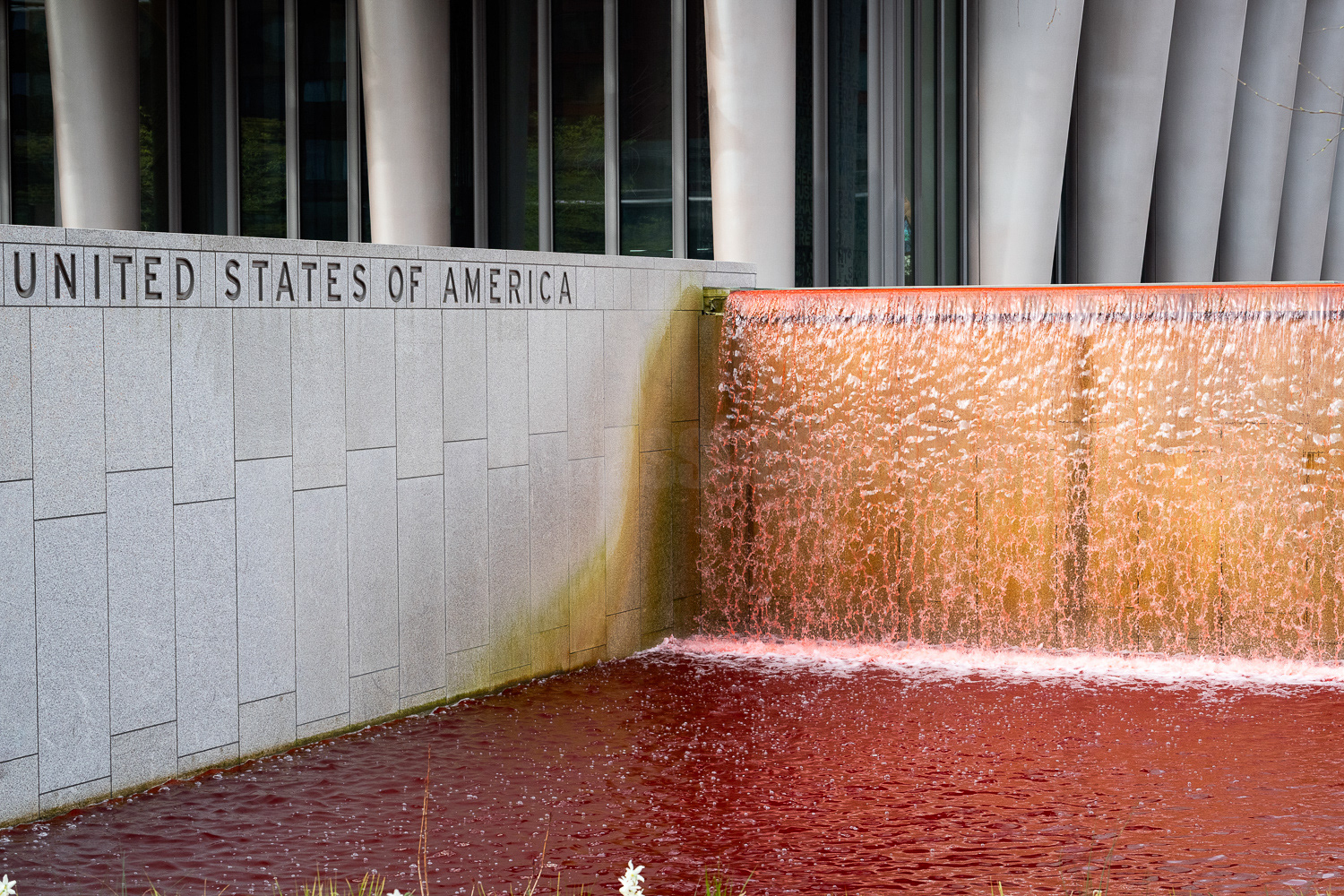 The US Embassy pond and waterfall filled with red dye in protest at arms sales to Israel. © Ron Fassbender