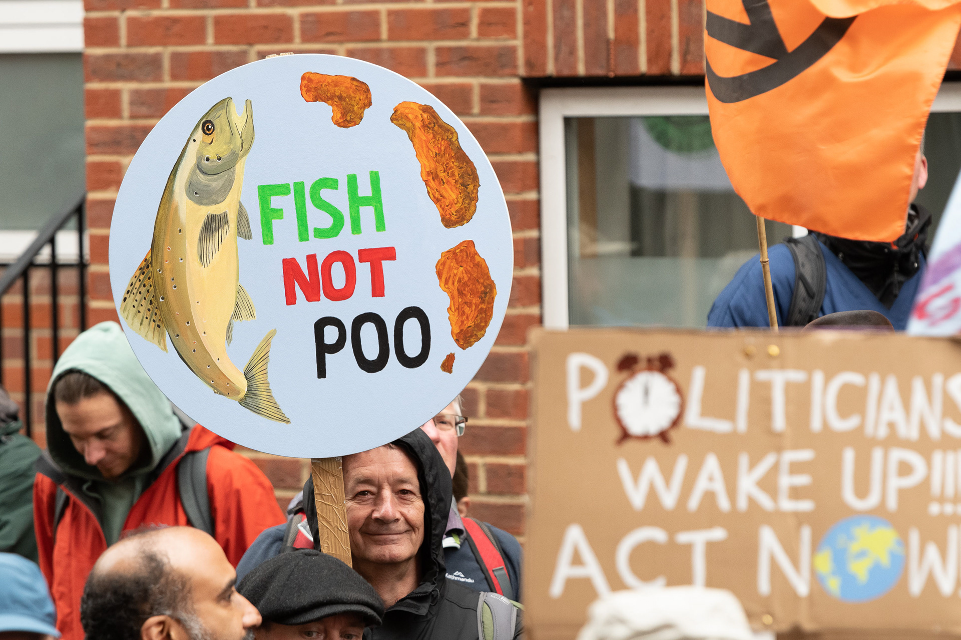 'Fish Not Poo' - a reference to worsening water pollution © Ron Fassbender
