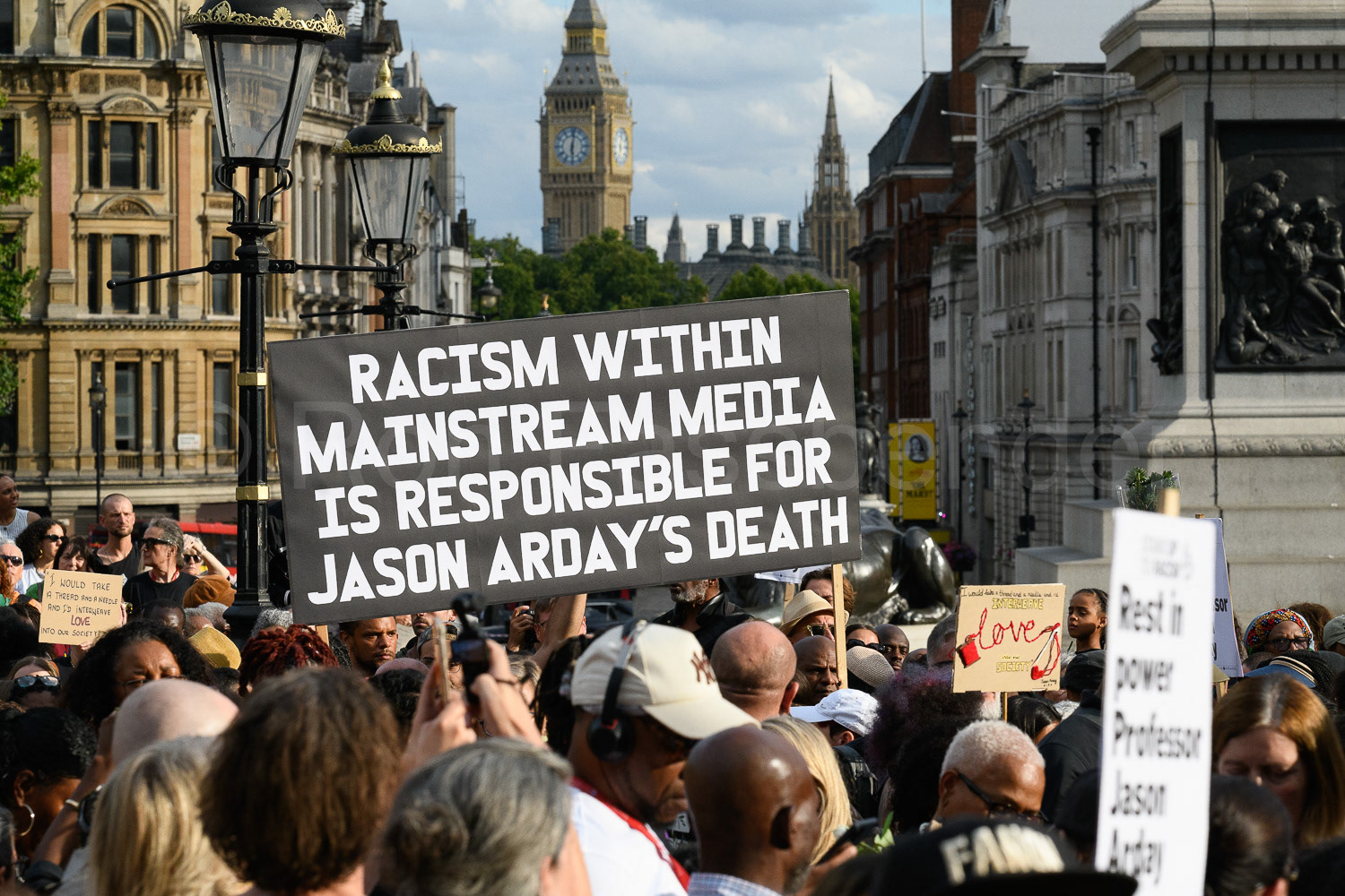 A large placard is shown in Trafalgar Square during a vigil for  Professor Jason Arday