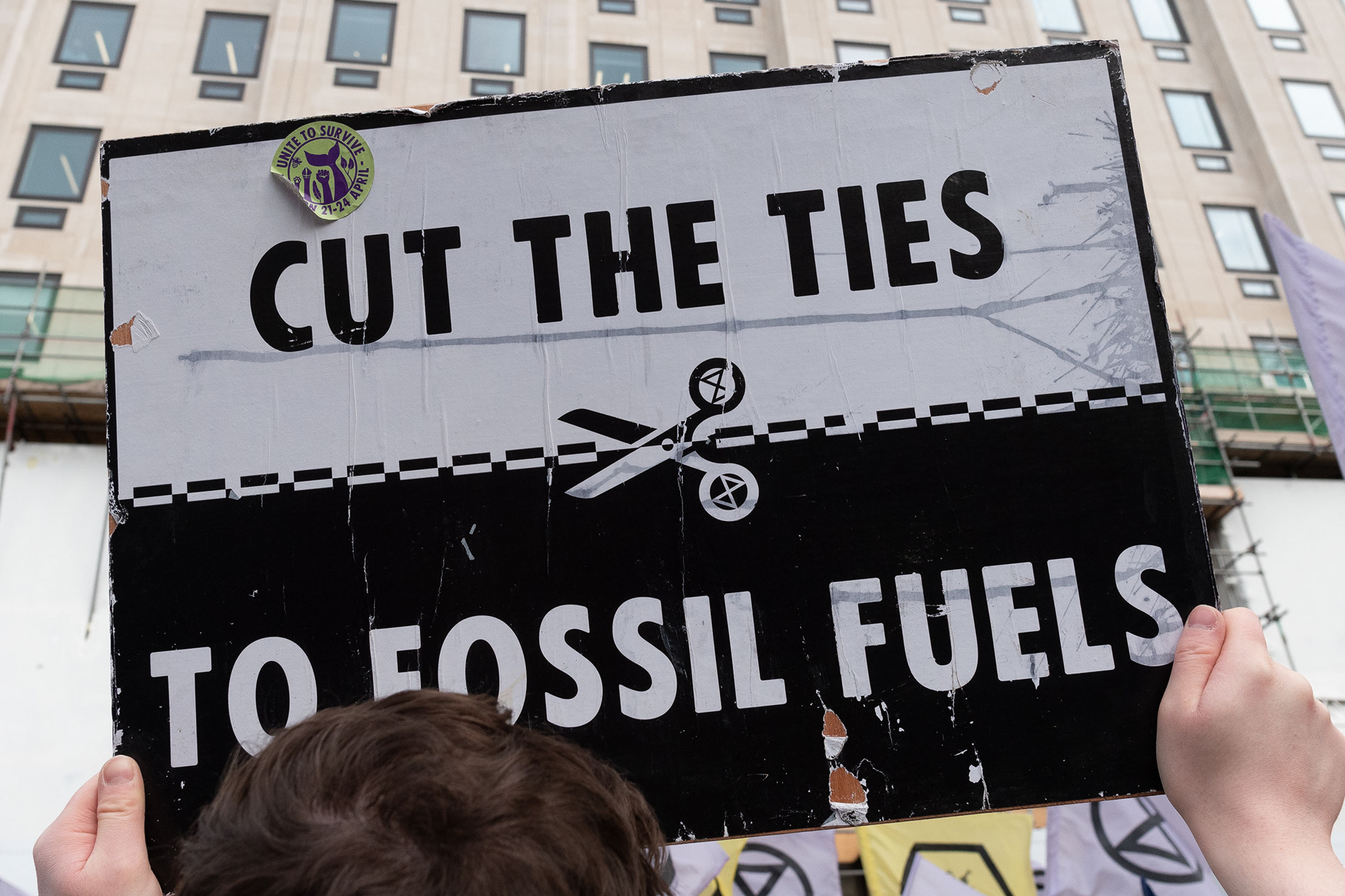 Cut The Ties To Fossil Fuels placard outside Shell oil HQ © Ron Fassbender