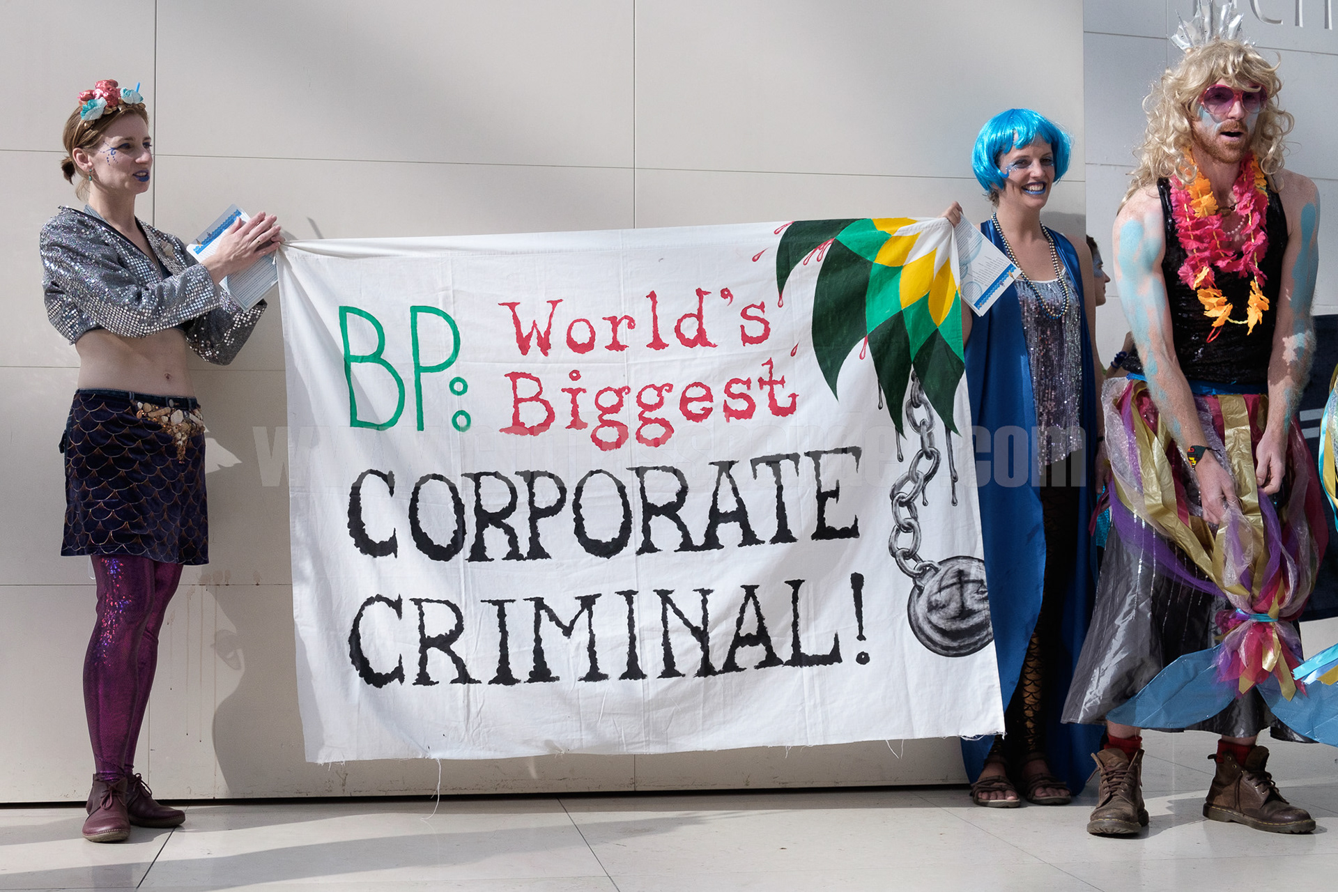 Activists hold a banner proclaiming oil company BP a "corporate criminal" while protesting BP sponsorship of the British Museum. © Ron Fassbender