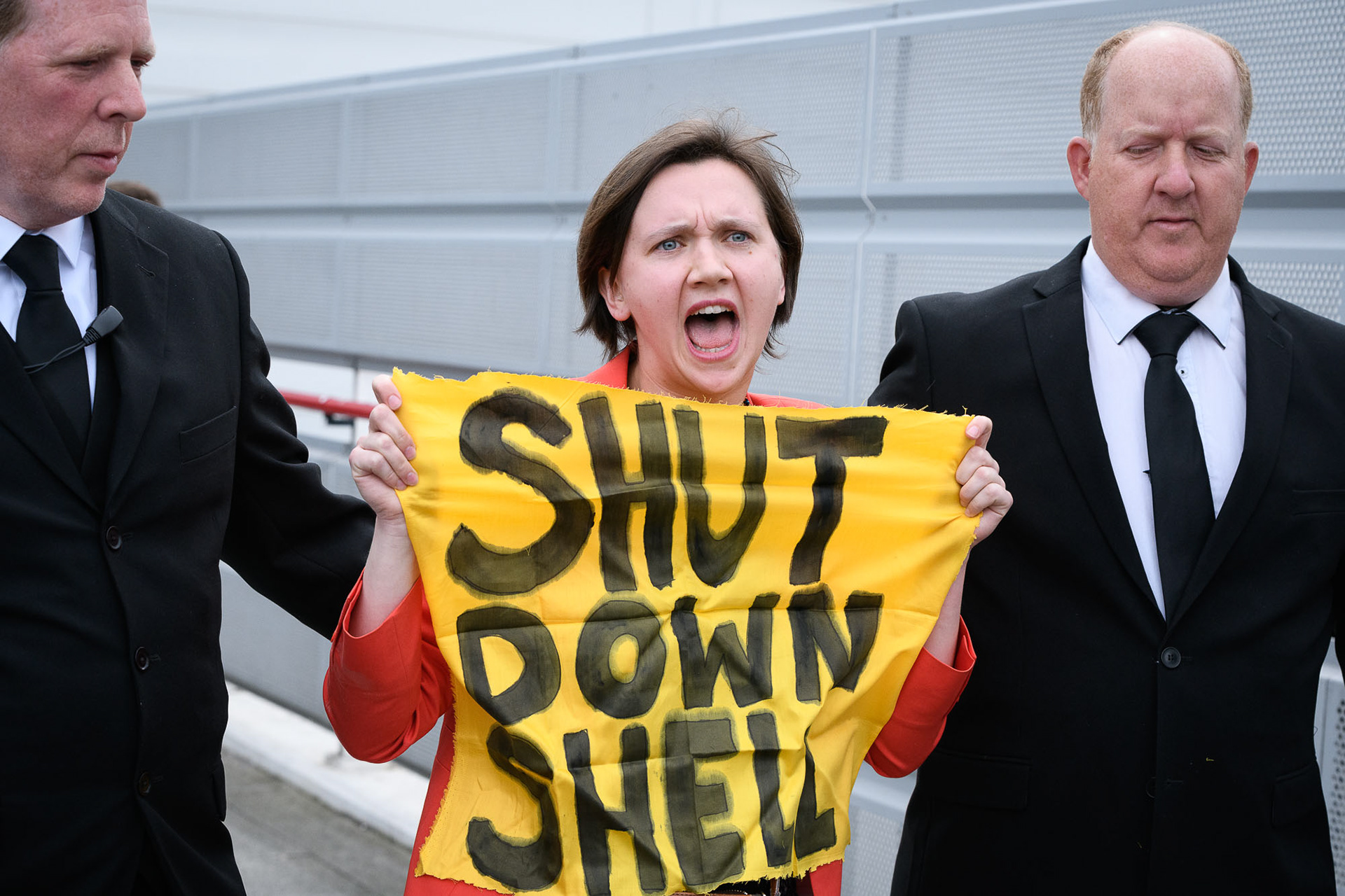 A climate activist is ejected from the AGM of oil company Shell. © Ron Fassbender