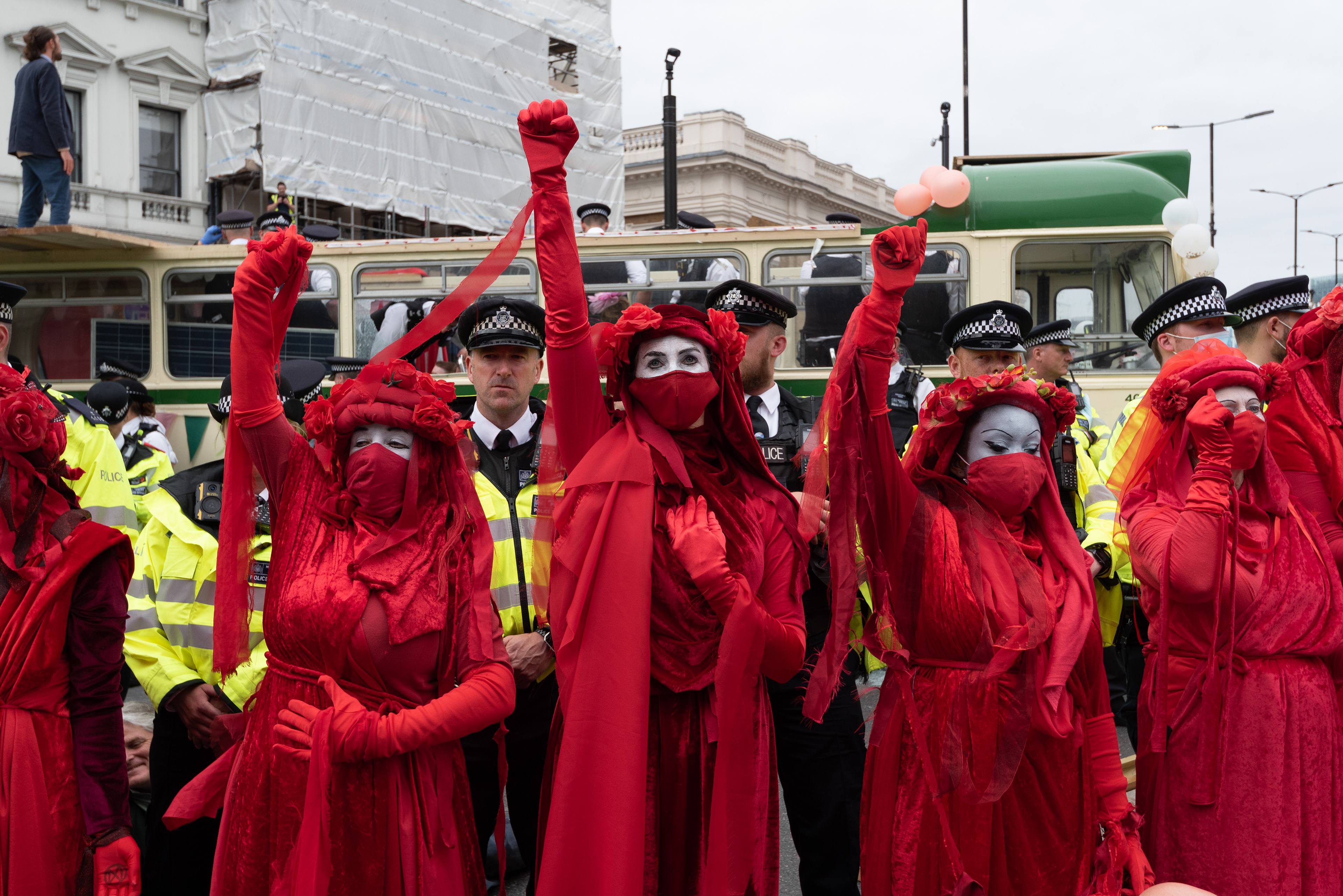 Red Rebel Brigade at London Bridge, blockaded by a vintage bus. © Ron Fassbender
