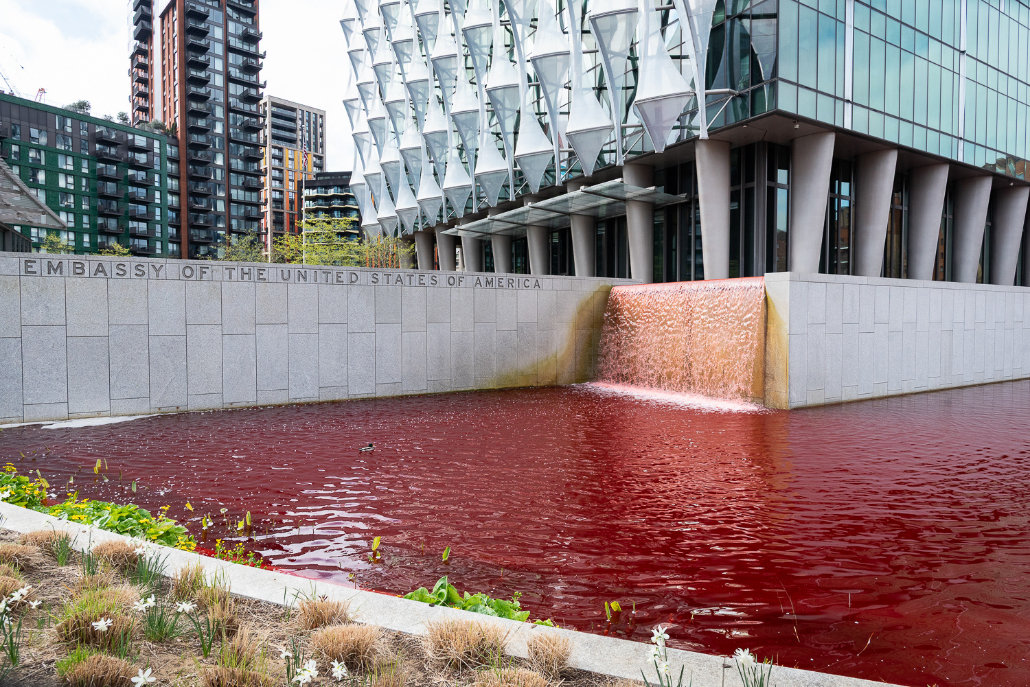 The US Embassy pond and waterfall filled with red dye in protest at arms sales to Israel. © Ron Fassbender