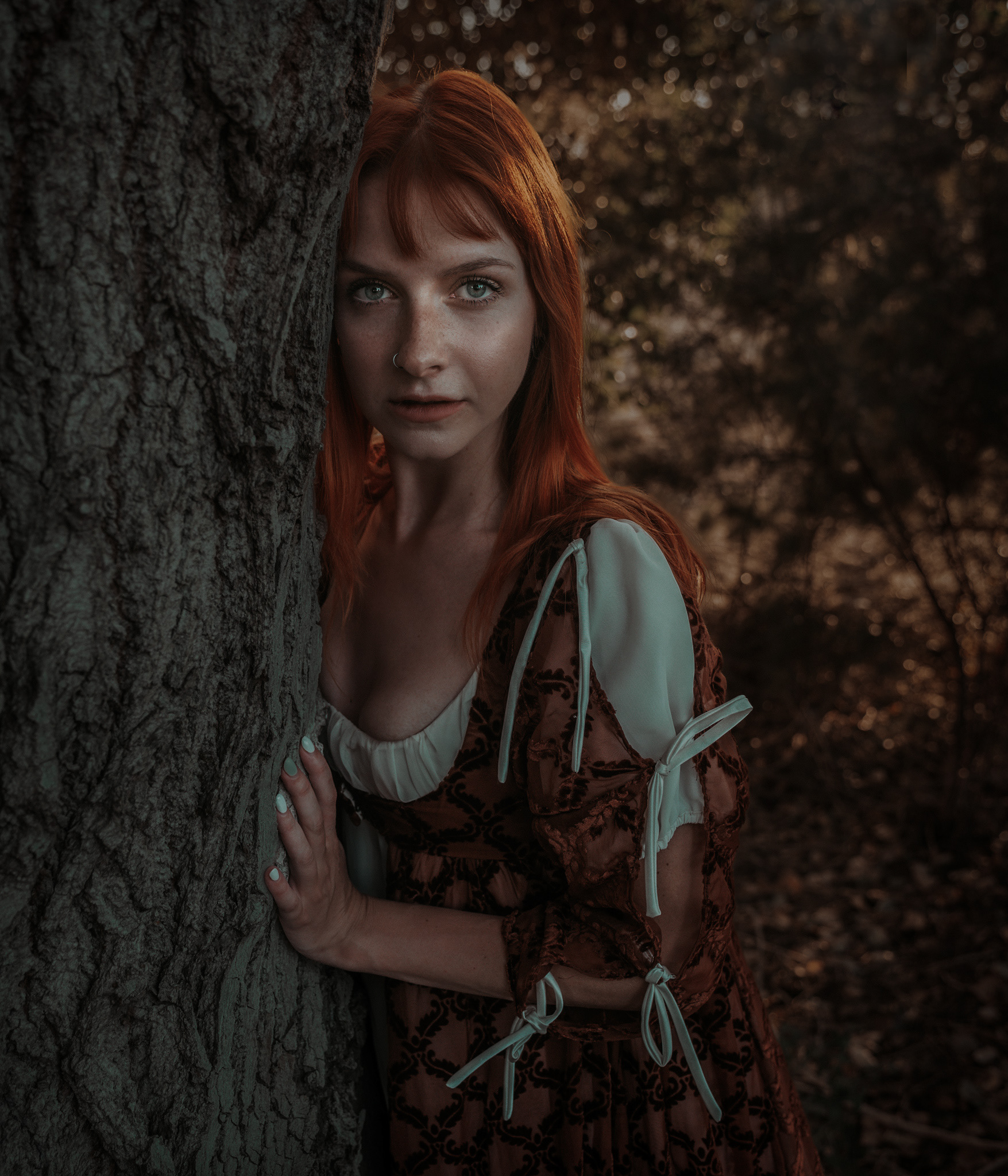Moody cinematic portrait of a red-haired woman with dramatic lighting