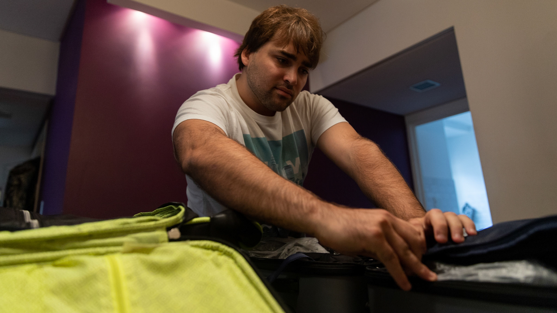 In this April 2, 2019, photo, Tomás Ruiz, 27, checks his baggage at his mother's house in the City of Buenos Aires, Argentina. Before moving to Dublin, Ireland in search of work.