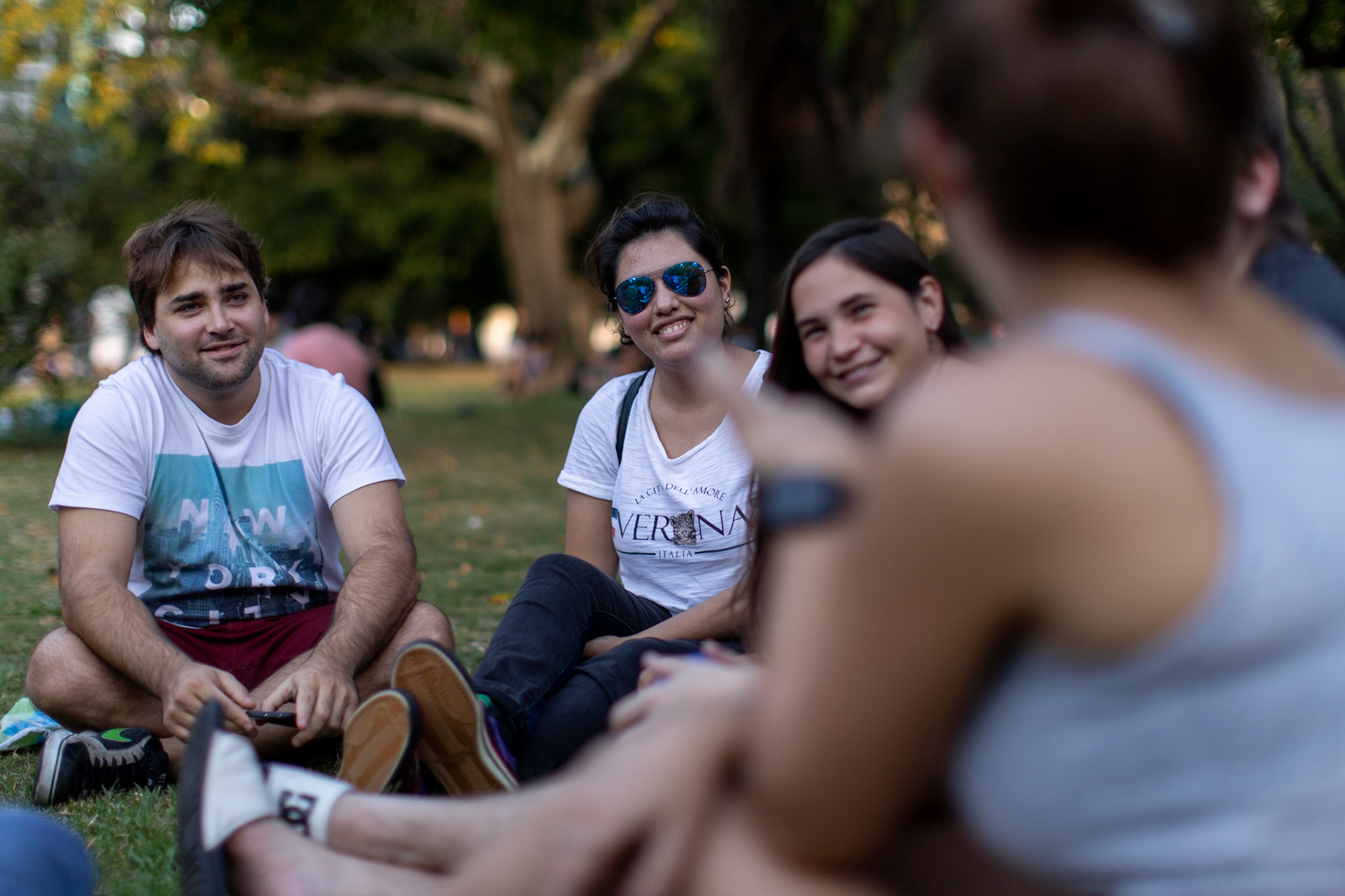 In this April 2, 2019, photo, Tomás Ruiz, 27, left, hangs out with his friends, Maria Julia Zuccotti, Micaela D’ambrosio, Luciano Maruca and Dolores Baglietto Biurrun, from left to right, at the Las Heras park in the City of Buenos Aires, Argentina. Before moving to Dublin, Ireland in search of work.