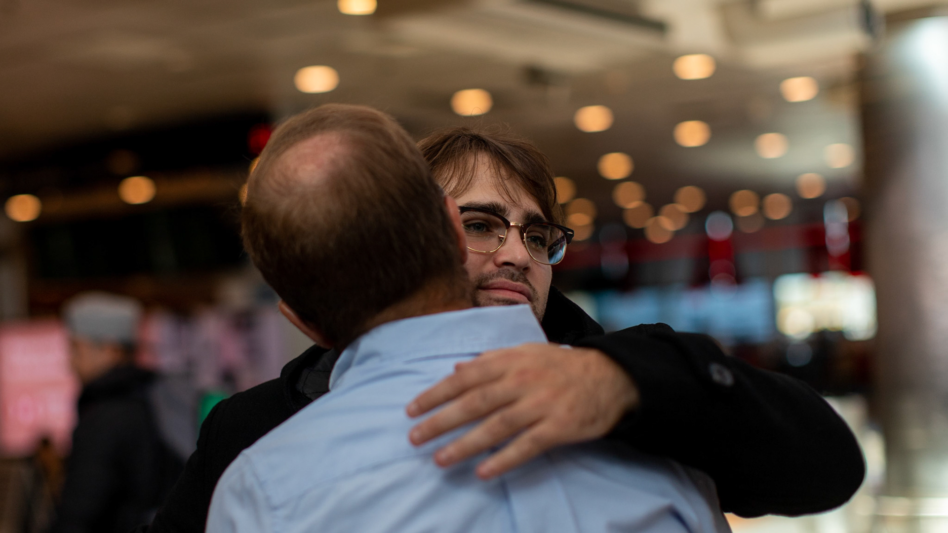 In this April 4, 2019, photo, Tomás Ruiz, 27, hugs his father, Pablo Ruiz, at International Airport Ministro Pistarini, in Ezeiza, Buenos Aires, Argentina. Before moving to Dublin, Ireland in search of work.
