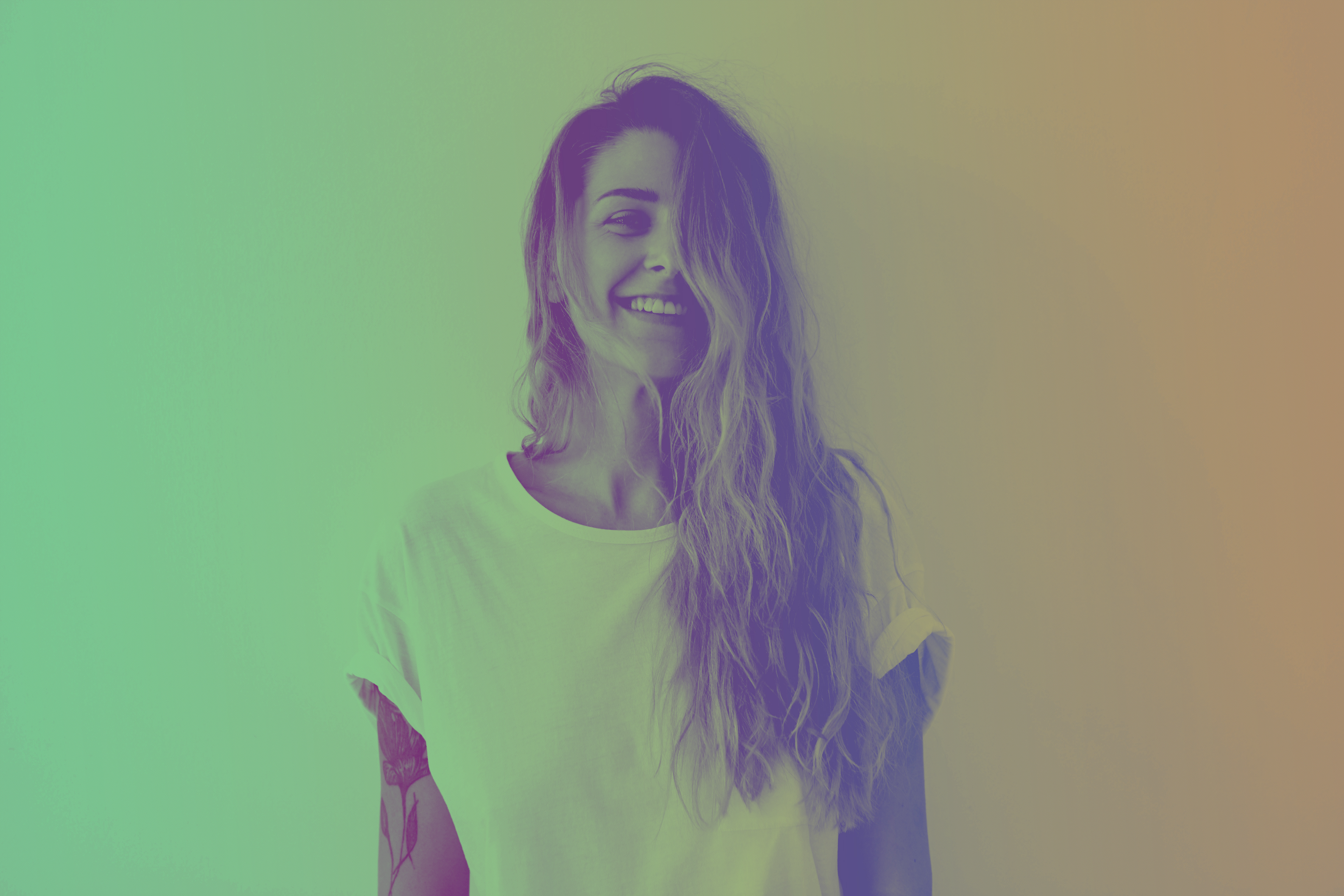 Side profile portrait of a woman against a pale green background.