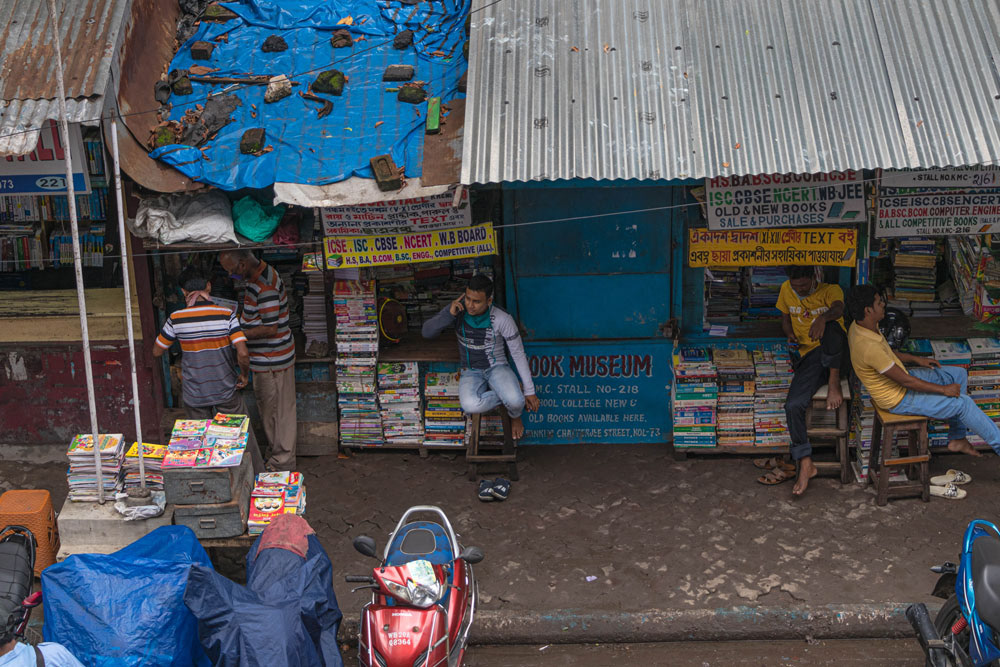 Book stall employees seated in front of their shops
