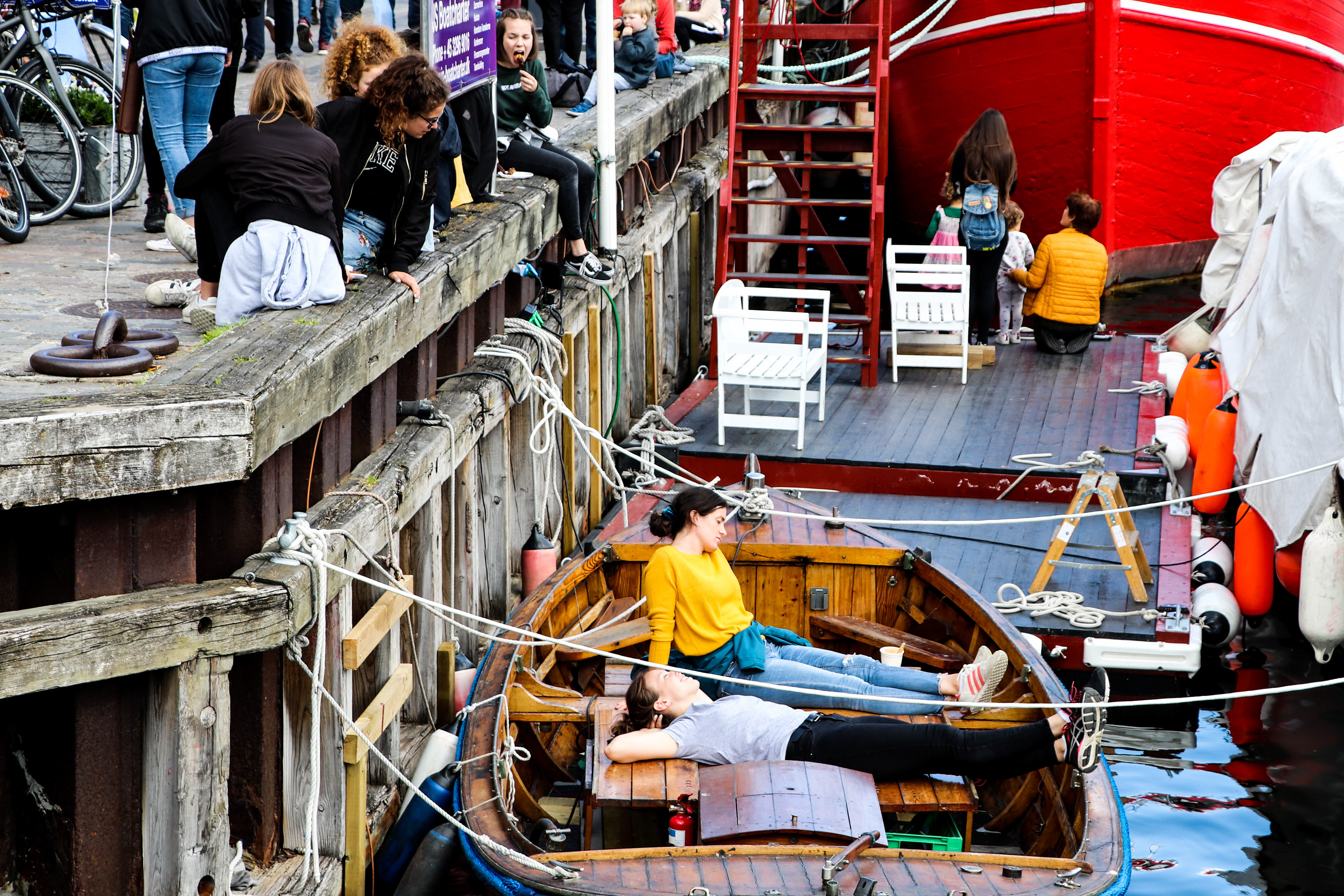 Soaking in the sun at Nyhavn harbor, Copenhagen, Denmark