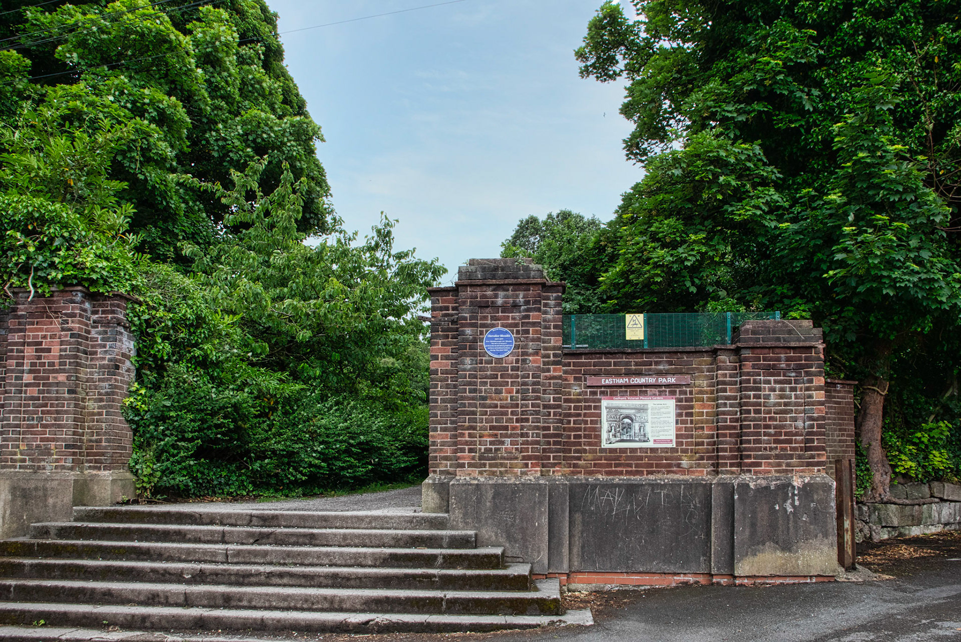 Entrance to Eastham Woods - was the Jubilee Arch. Blue Plaque to Blondin