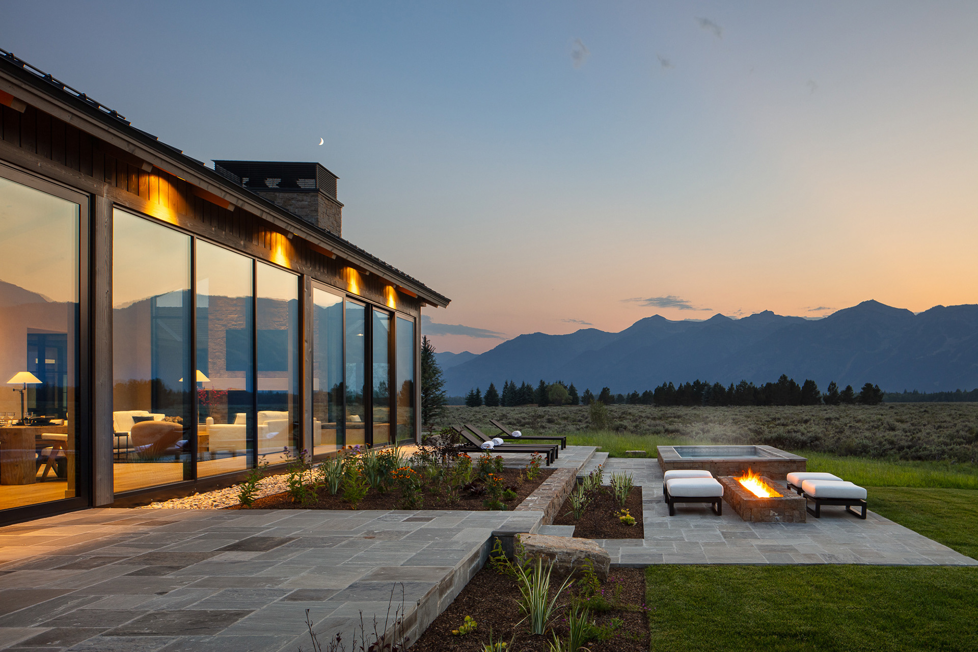 Starfall home in Jackson Hole Wyoming at sunset. Photography by architecture photographer Aaron Kraft Krafty Photos. Architectural design by Tyler Wilson Architects, building by Teton Heritage Builders with interior design by Nida Risto. Aaron Kraft twilight exterior photography
