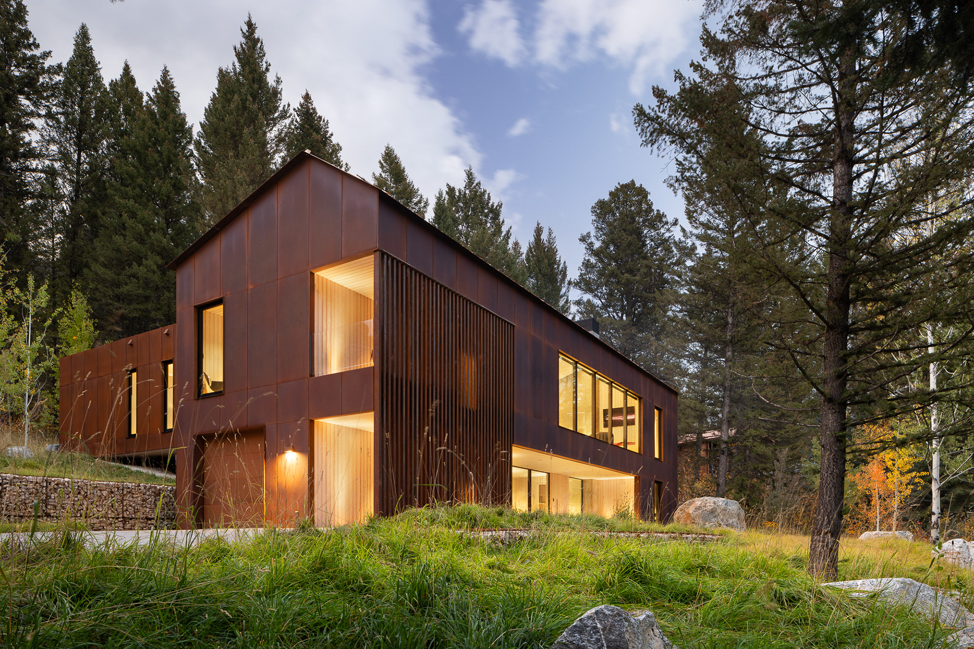 A modern home designed by clb architects in a fall setting in the forest. Photography by Aaron Kraft Krafty Photos