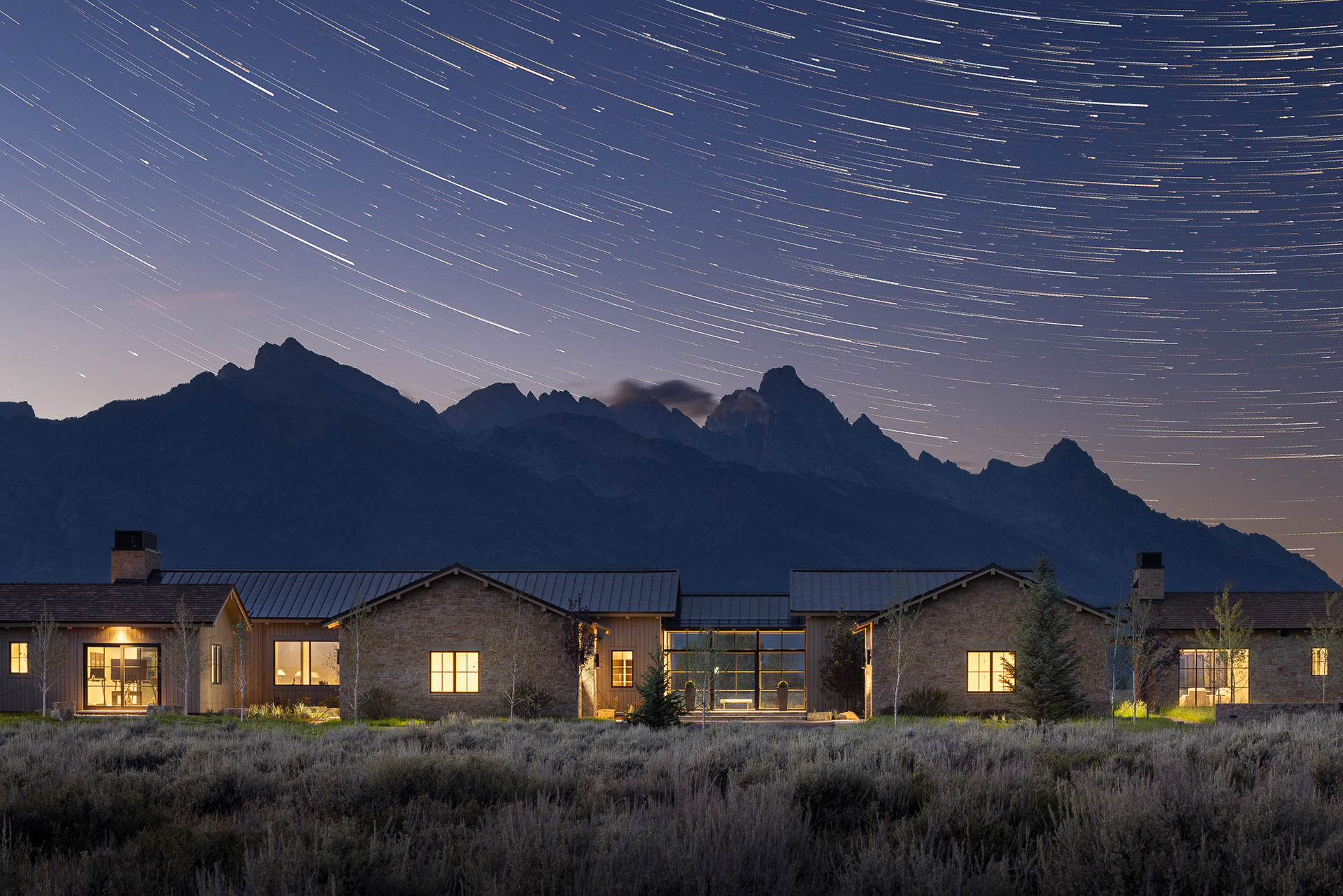 Starfall home in Jackson Hole Wyoming with star trails. Photography by architecture photographer Aaron Kraft Krafty Photos. Architectural design by Tyler Wilson Architects, building by Teton Heritage Builders with interior design by Nida Risto. Astrophotography