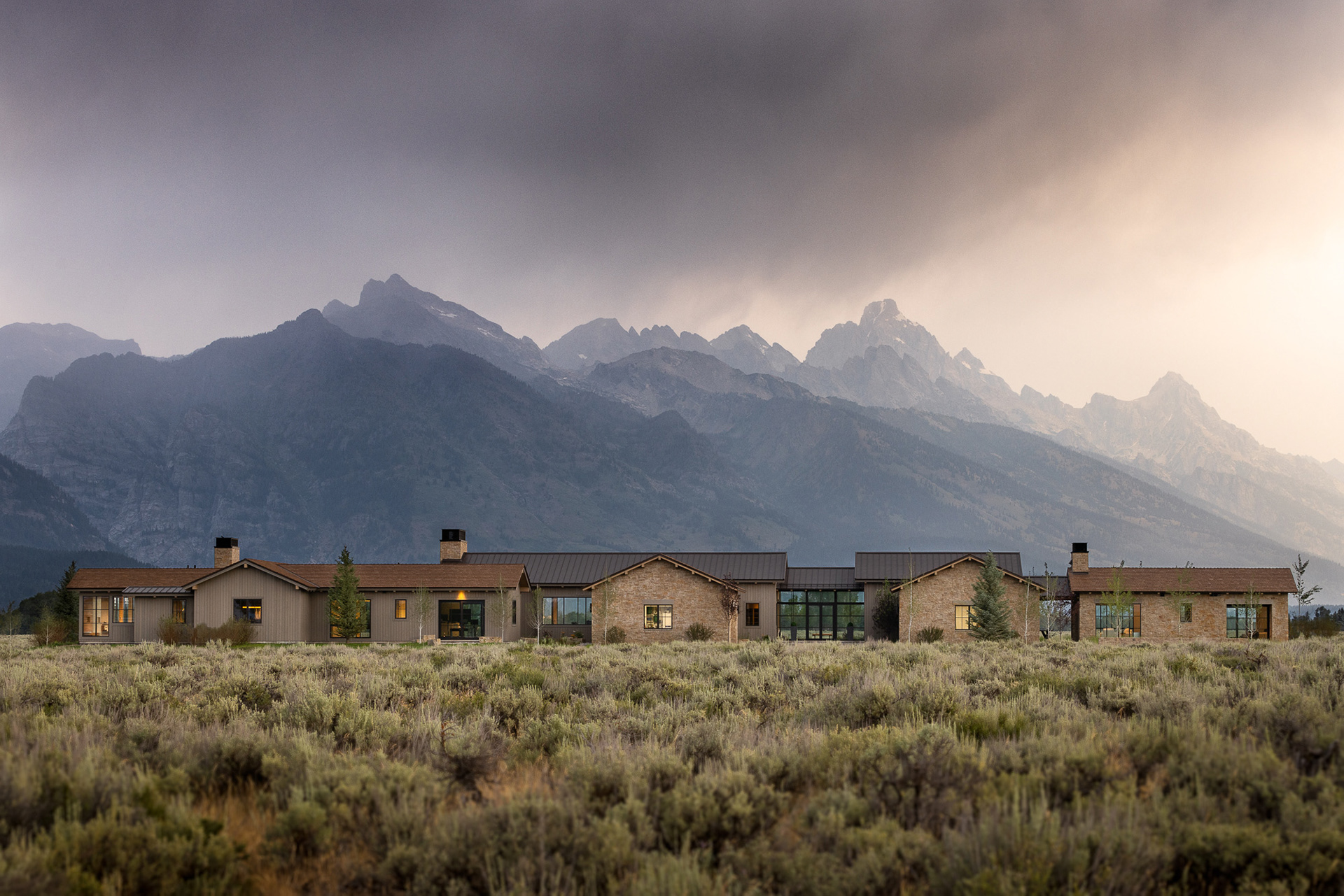 Starfall home in Jackson Hole Wyoming at sunrise. Photography by architecture photographer Aaron Kraft Krafty Photos. Architectural design by Tyler Wilson Architects, building by Teton Heritage Builders with interior design by Nida Risto. 