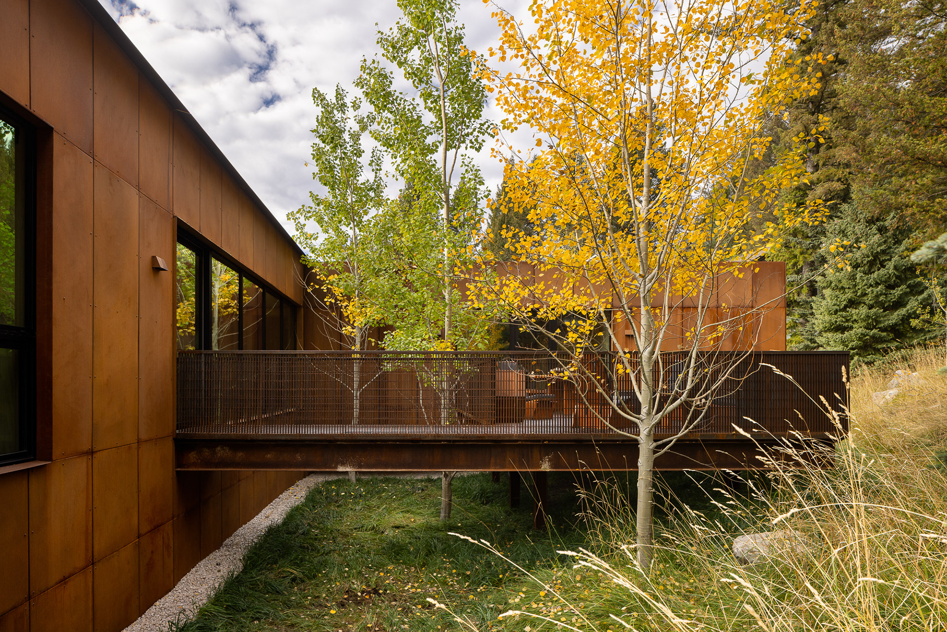 A modern home designed by clb architects in a fall setting in the forest. Photography by Aaron Kraft Krafty Photos