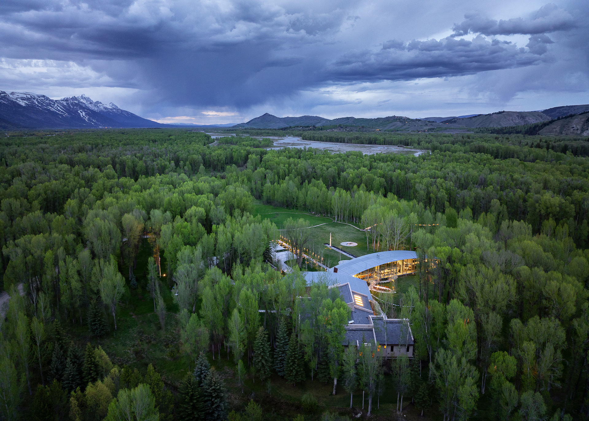 River House designed by architect Wallace Cunningham photographed at sunset in early spring. Photograph by architectural photographer aaron kraft krafty photos. architecture in Jackson Hole Wyoming. aerial drone image