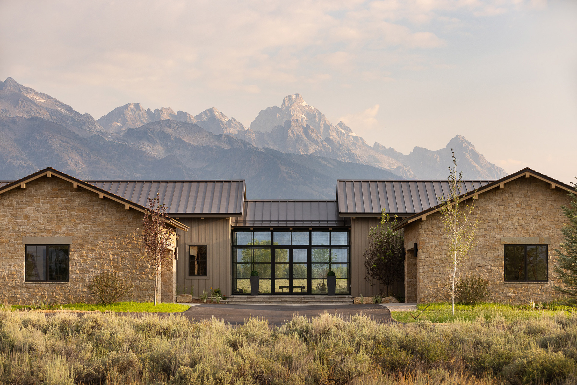 Starfall home in Jackson Hole Wyoming at sunrise. Photography by architecture photographer Aaron Kraft Krafty Photos. Architectural design by Tyler Wilson Architects, building by Teton Heritage Builders with interior design by Nida Risto. Aaron Kraft